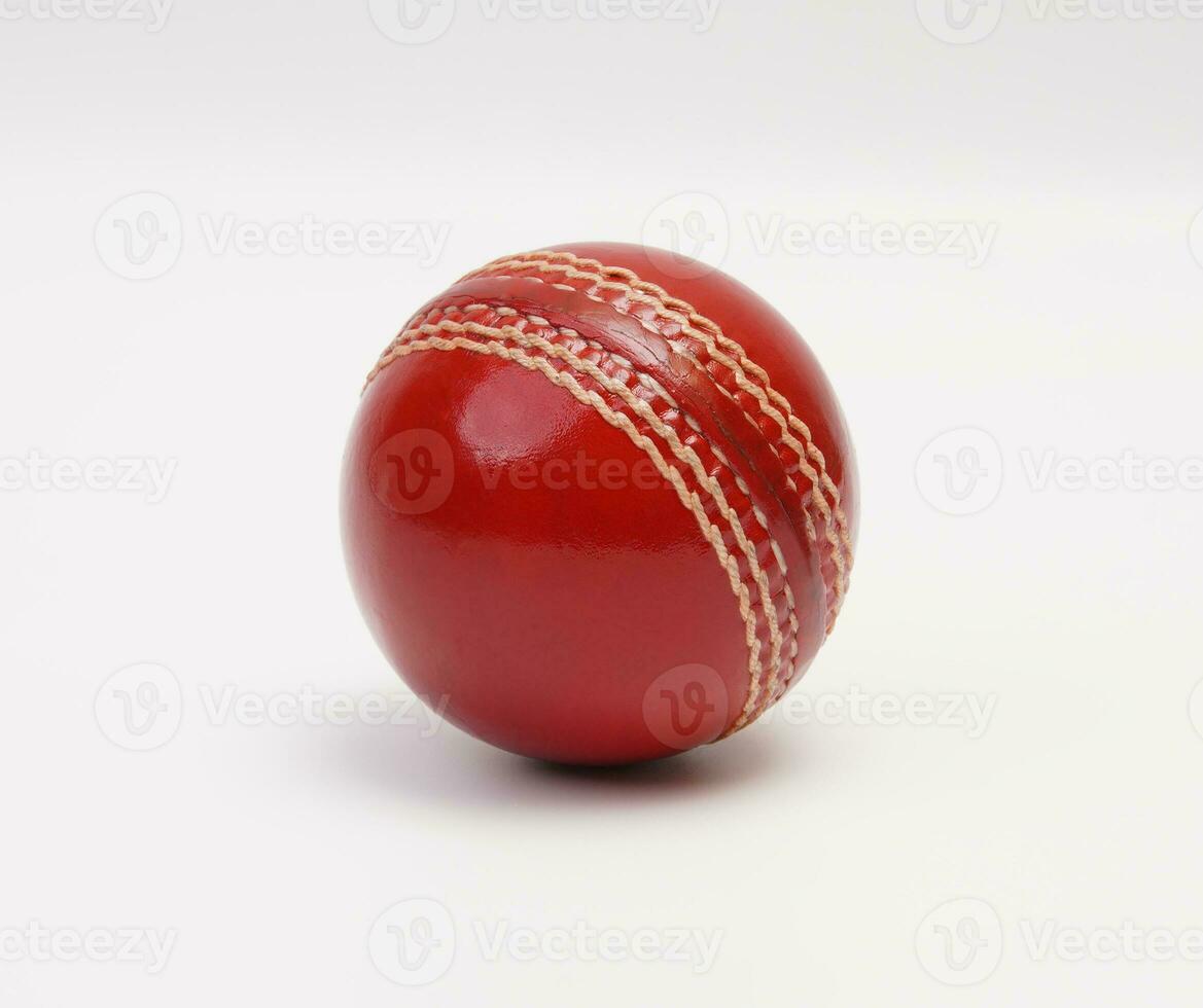 A Shiny New Test Match Cricket Ball Leather Hard Circle Stitch Closeup Picture On White Background photo