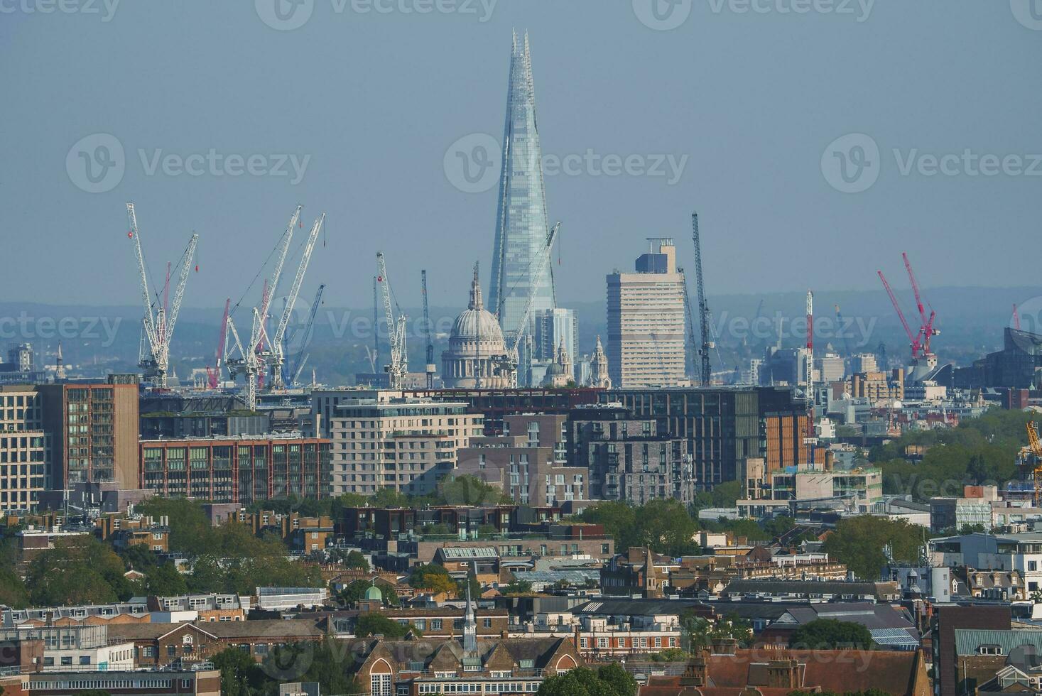 Scenic view of cityscape with blue sky in background at London photo