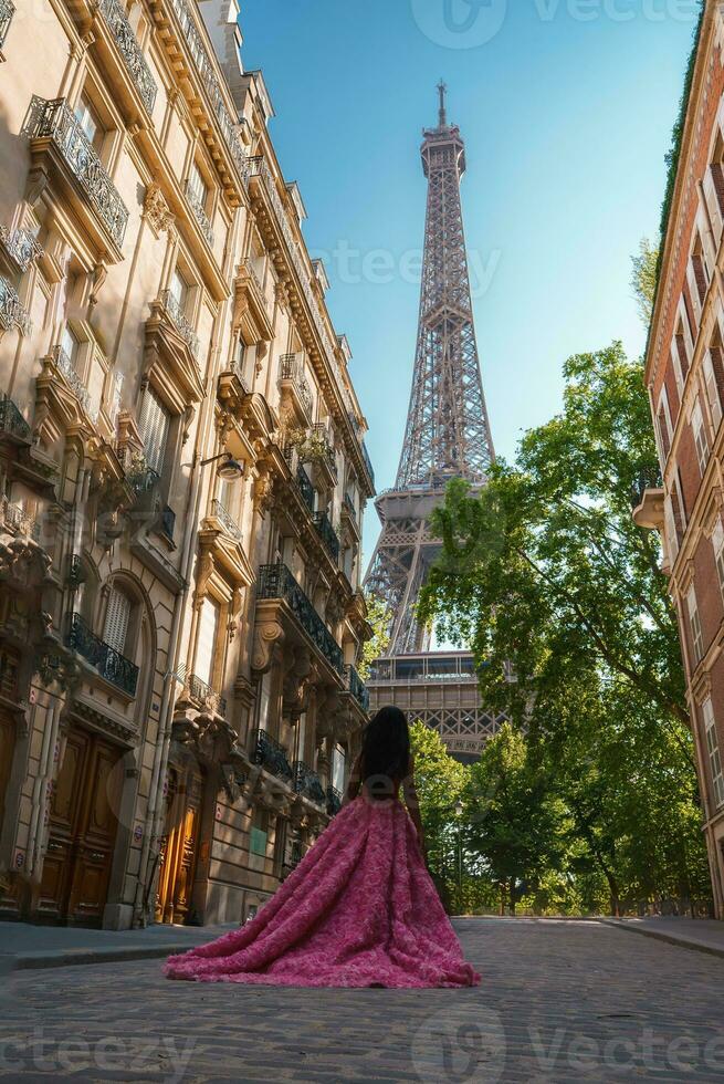 Sad Woman in Pink Dress near Eiffel Tower photo