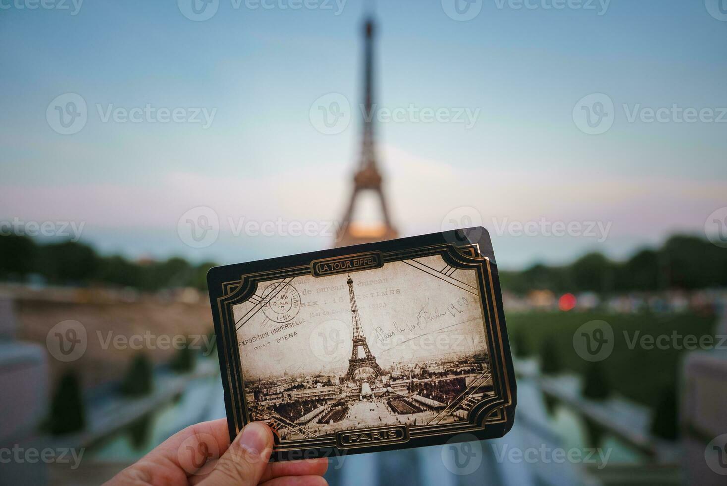 Vintage Eiffel Tower Photo in Hand at Dusk