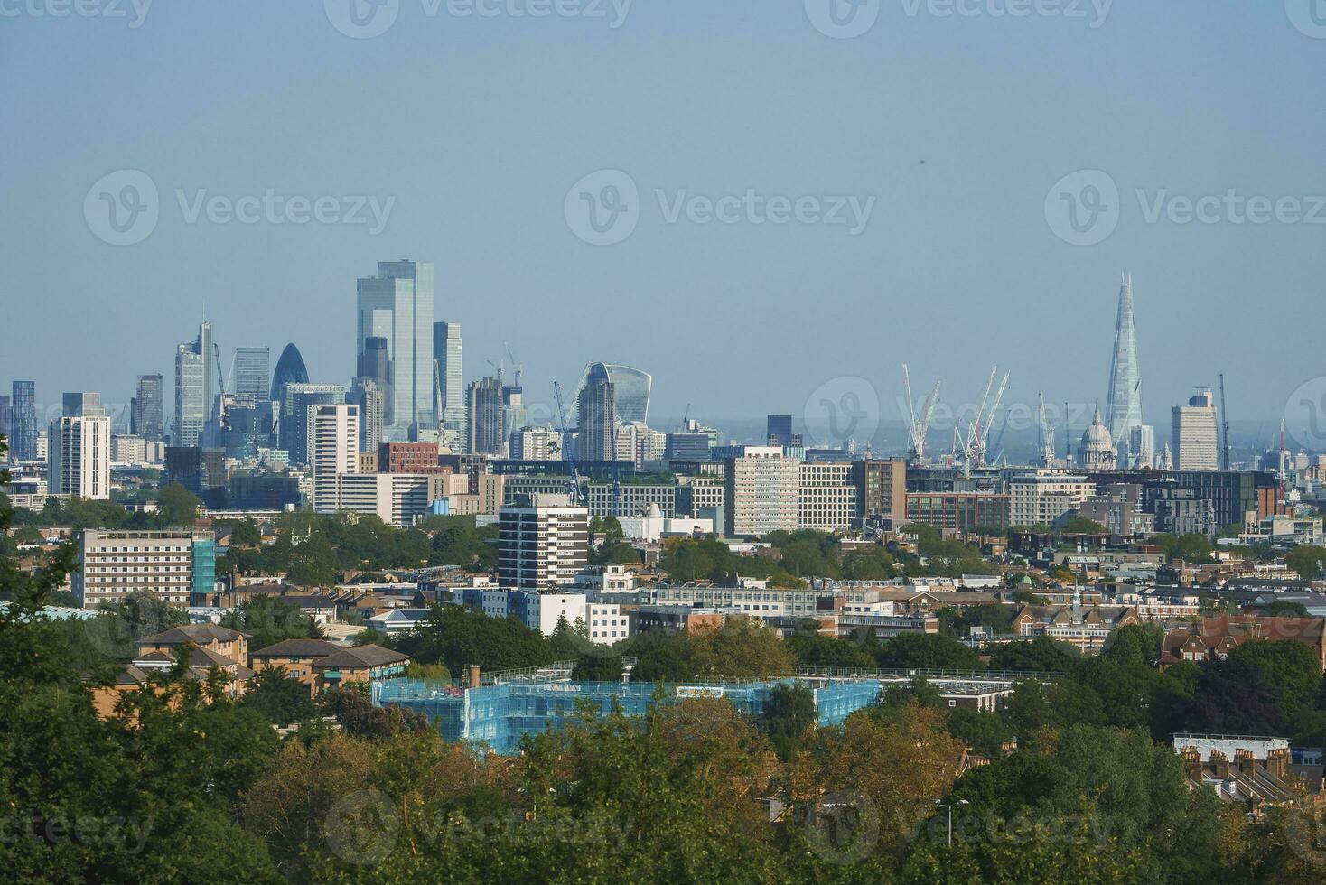 Scenic view of London cityscape with blue sky in background photo