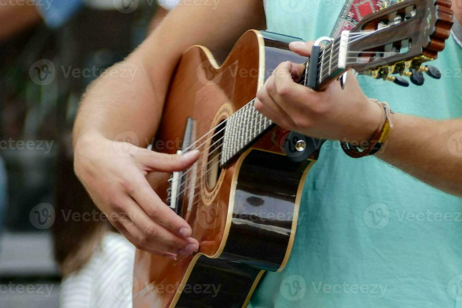 man playing an acoustic guitar in a park photo