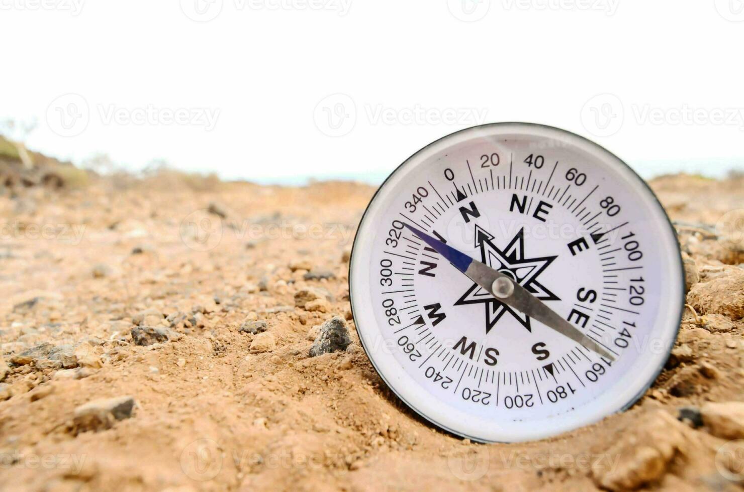 a compass is placed on the ground in the desert photo