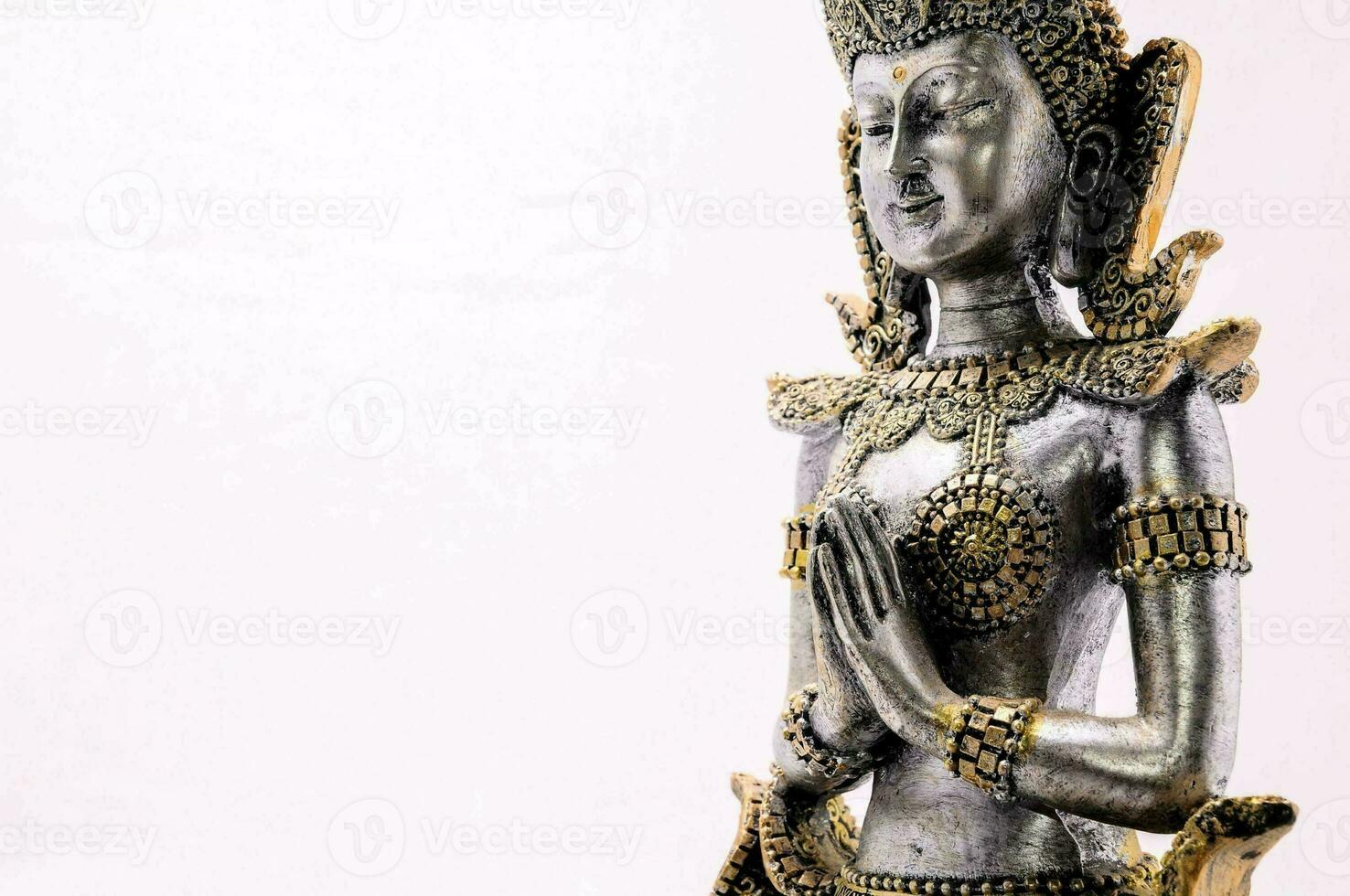 a statue of a thai goddess on a white background photo