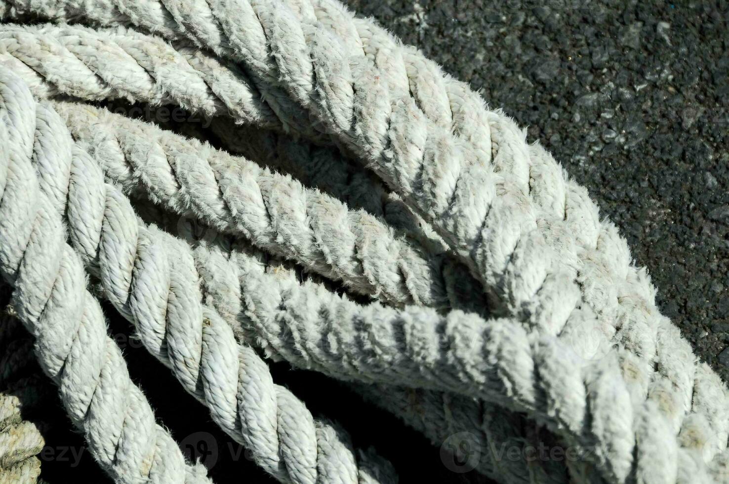a close up of a rope on a black surface photo