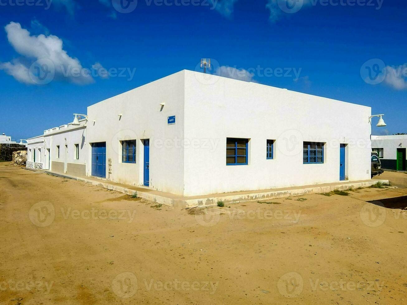 a white building with blue doors and windows photo