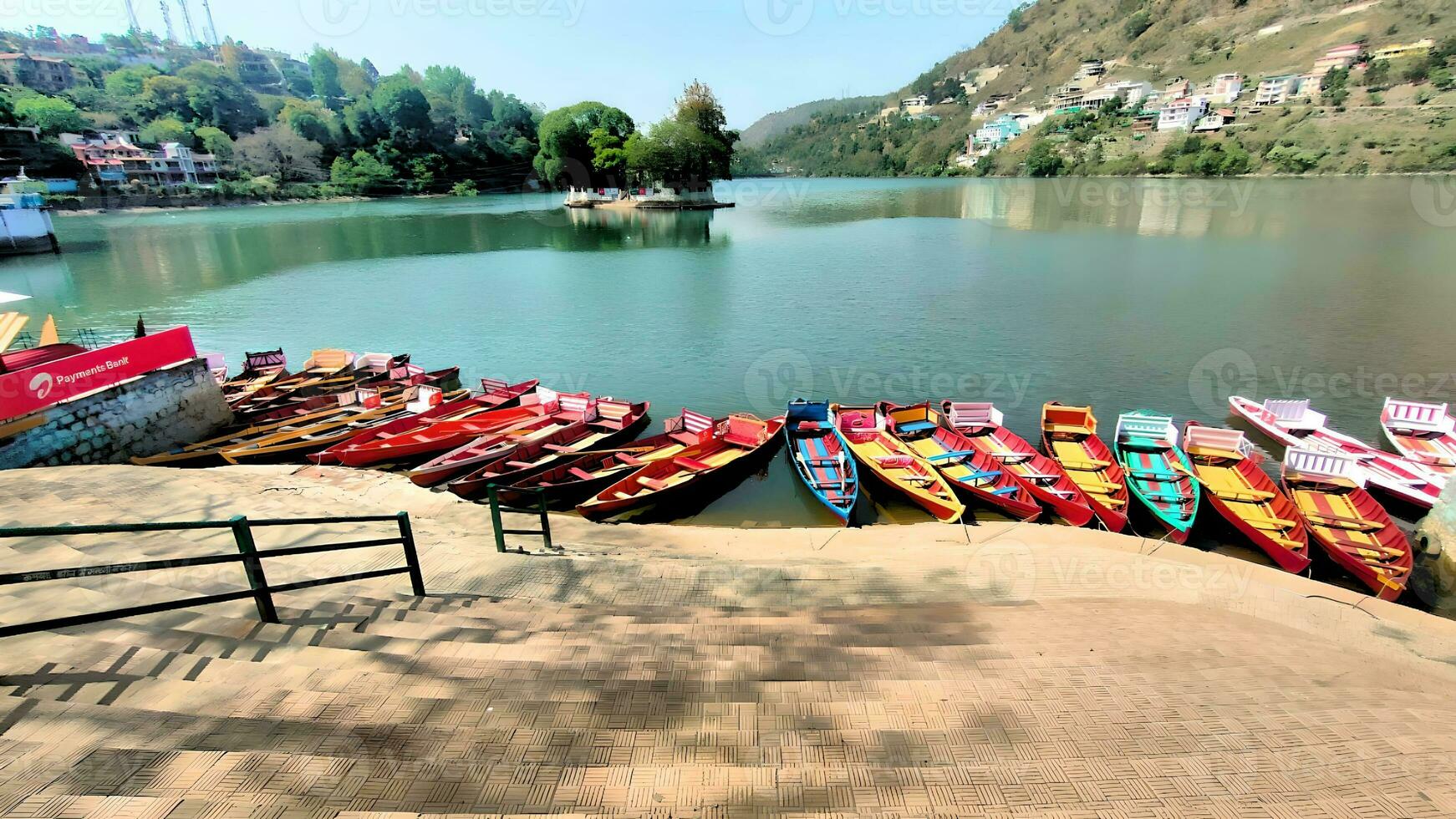 a row of colorful boats in the lake photo