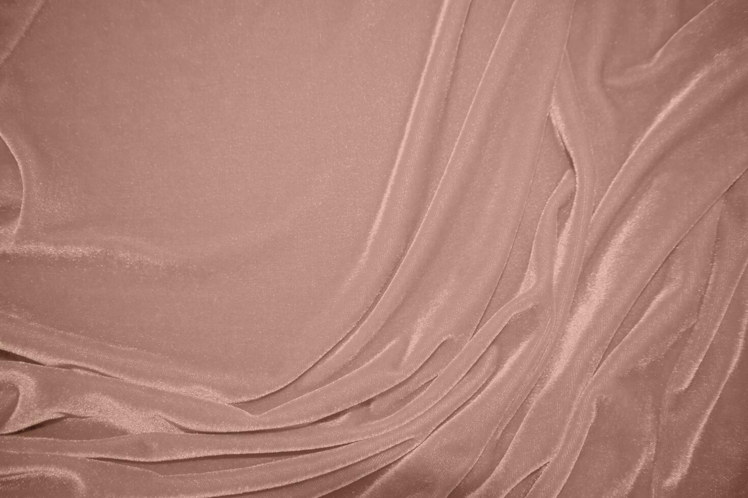 rose gold color velvet fabric texture used as background. blond color panne fabric background of soft and smooth textile material. crushed velvet .luxury golden tone for silk.pink gold photo