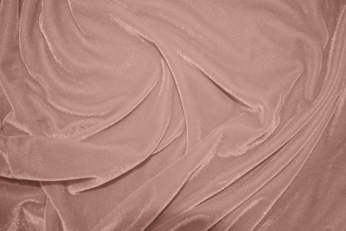 rose gold color velvet fabric texture used as background. blond color panne fabric background of soft and smooth textile material. crushed velvet .luxury golden tone for silk.pink gold photo