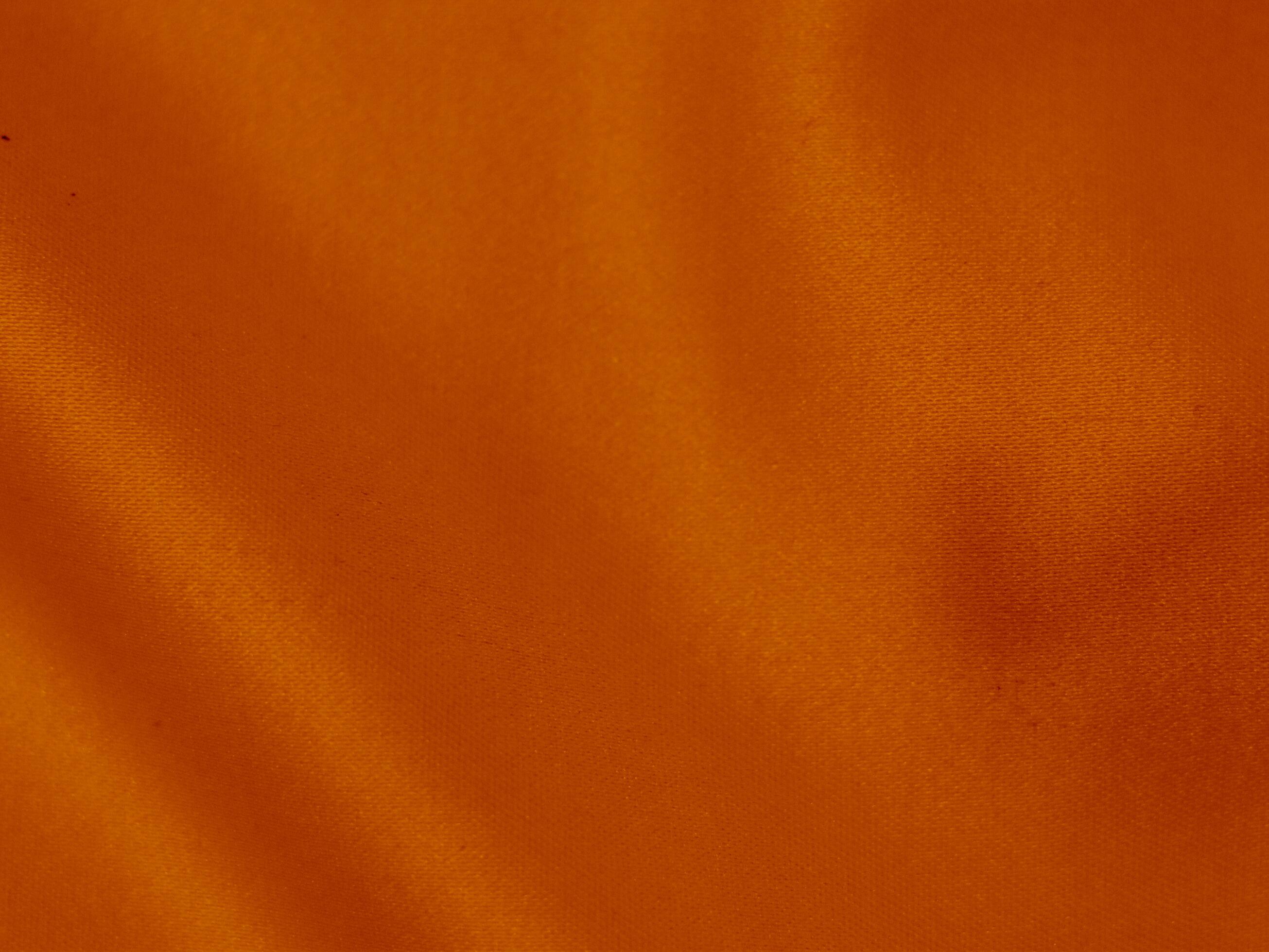 Orange velvet fabric texture used as background. orange fabric