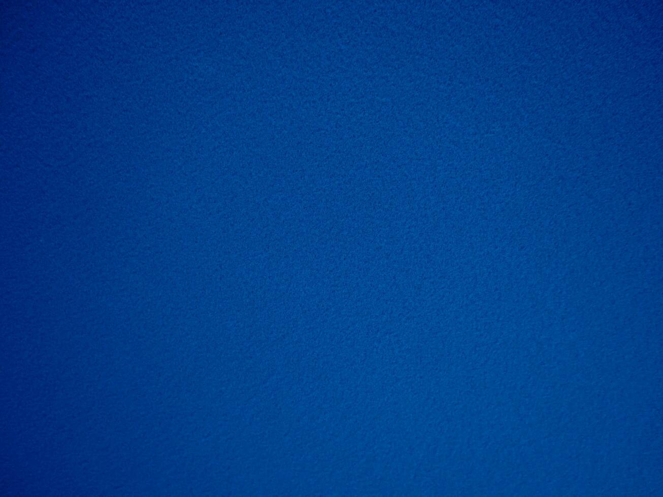 Felt blue soft rough textile material background texture close up,poker table,tennis ball,table cloth. Empty navy blue fabric denim background. photo