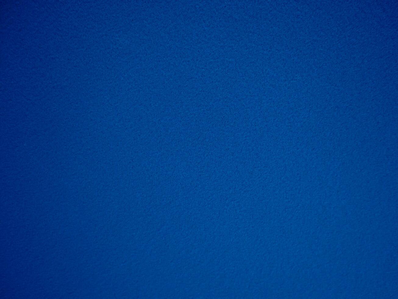 Felt blue soft rough textile material background texture close up,poker table,tennis ball,table cloth. Empty navy blue fabric denim background. photo