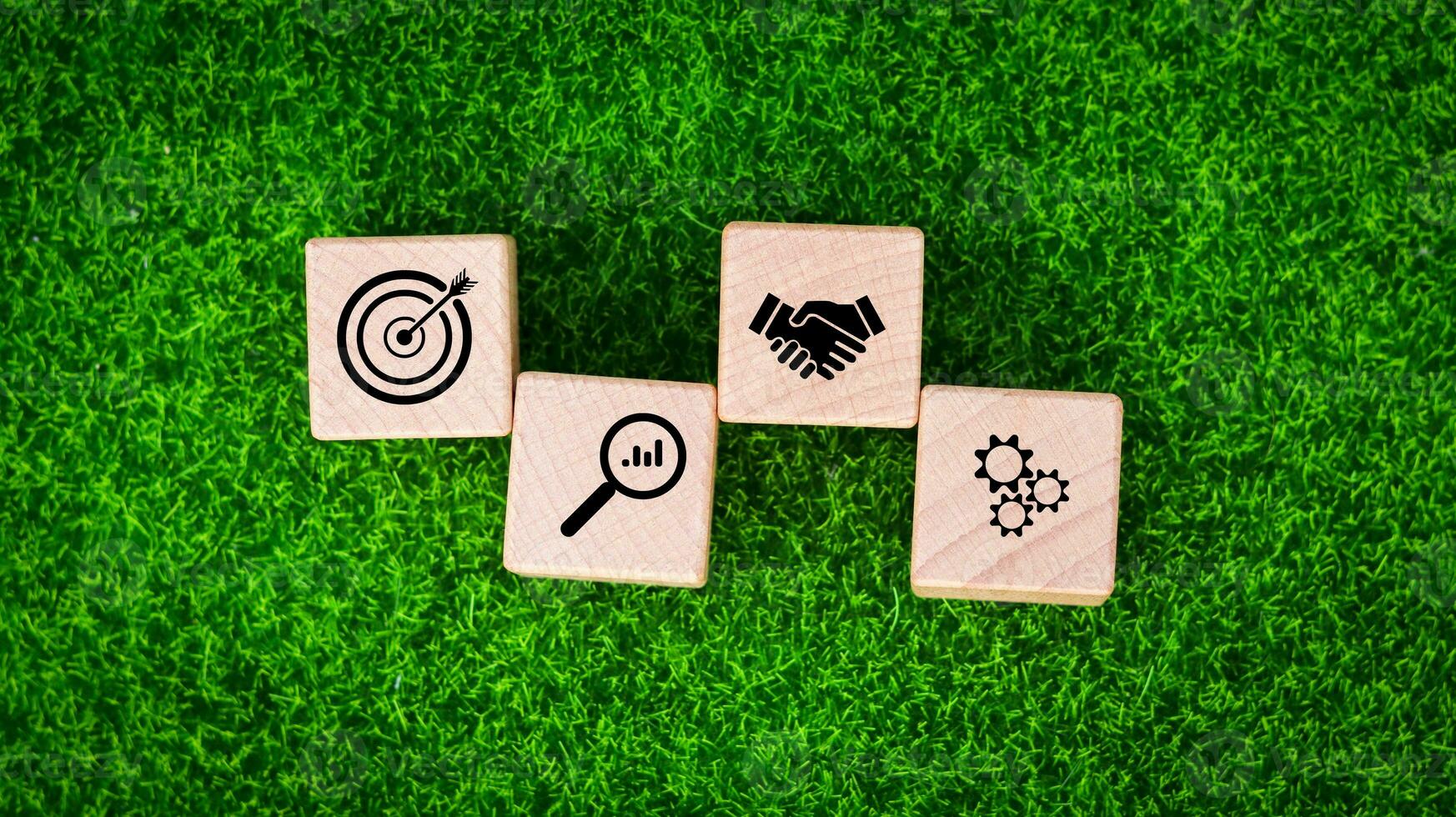 Businessman holding woods block cube with icon success of busines. purpose of doing business overcoming challenges Walking towards goals and winning. Sustainable business finance action plan photo