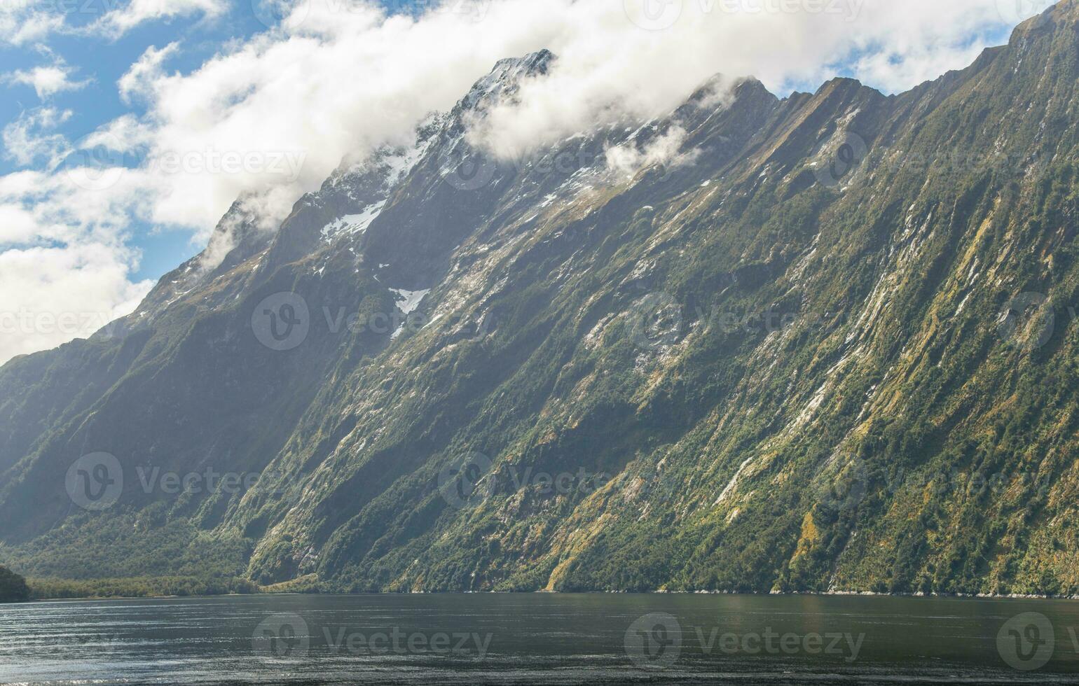 Side view of Mitre Peak is an iconic mountain in the South Island of New Zealand, located on the shore of Milford Sound. photo