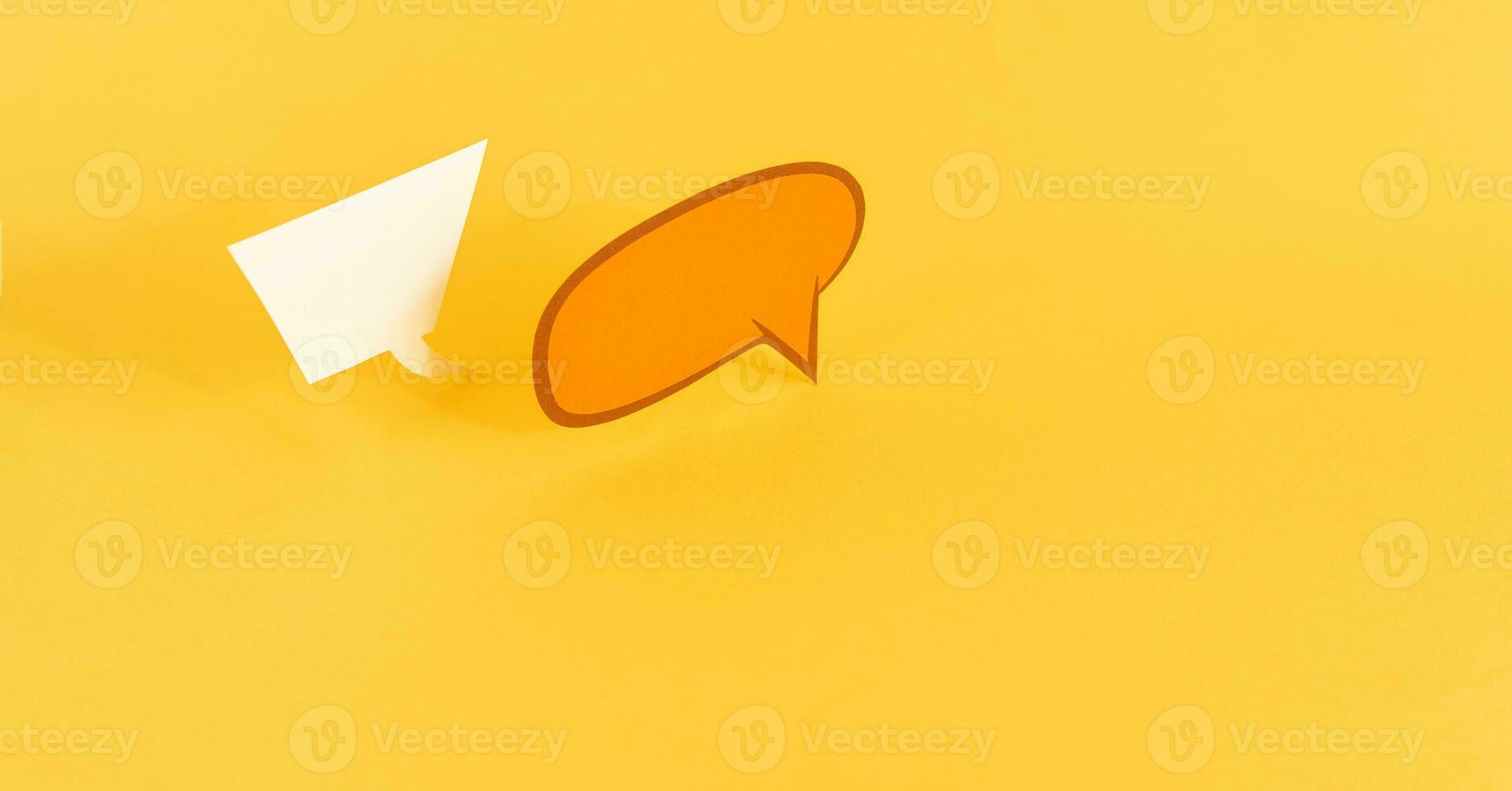 paper speech bubbles on yellow background photo