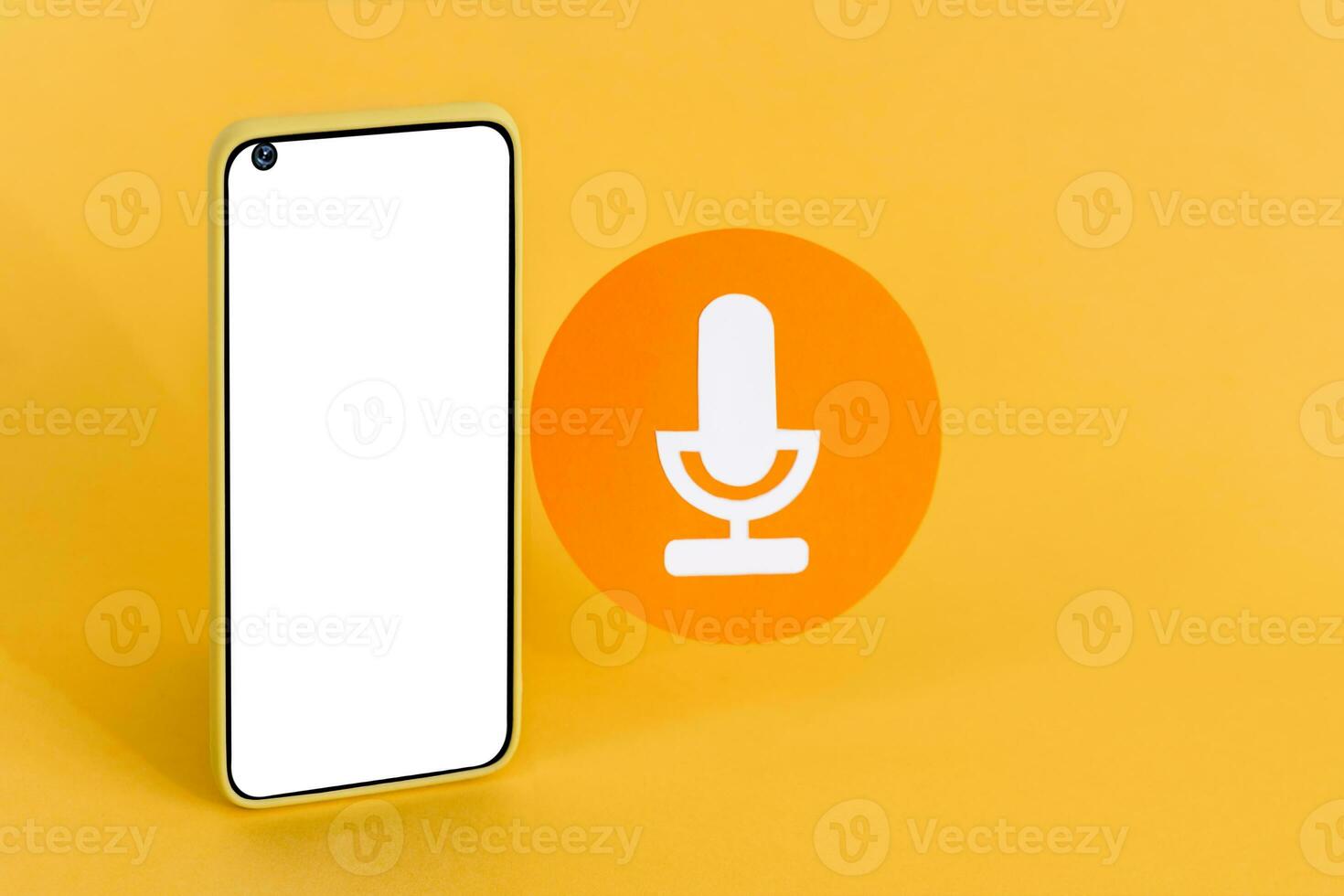 Smart phone with blank white screen and a microphone icon on pastel background. Communication and voice messaging concept. photo