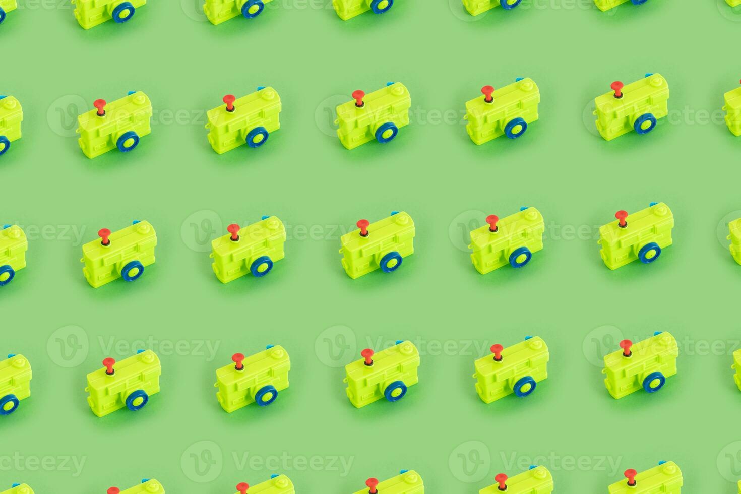 Green plastic photo camera pattern on pastel green background. Minimal concept.