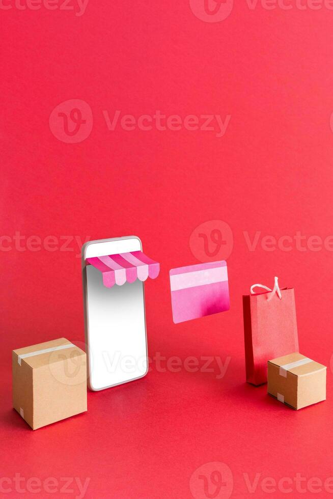 The concept of online shopping. Smart phone with shopping bag, delivery, boxes, and credit card. Promotion of digital stores. photo