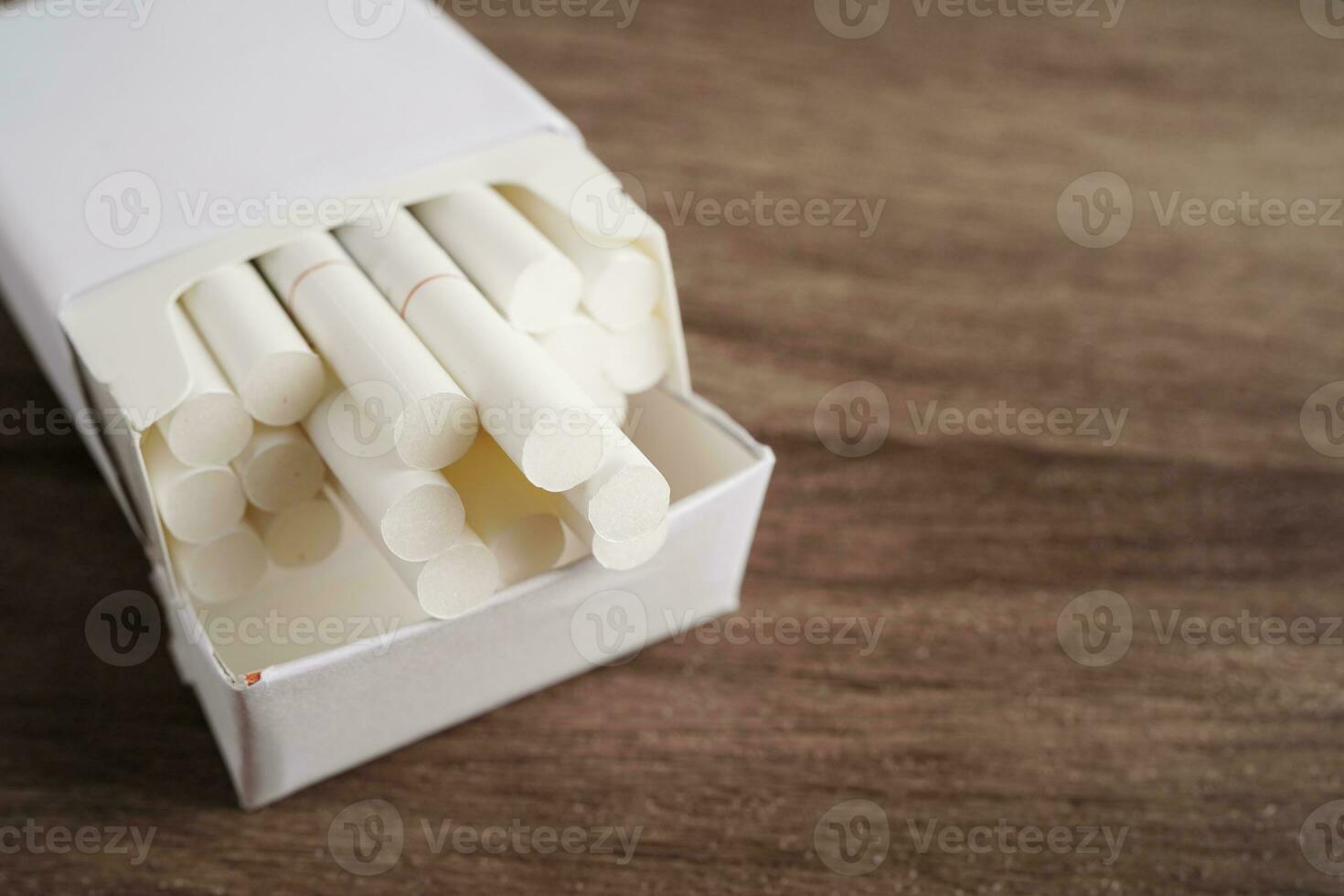Cigarette in pack, roll tobacco in paper with filter tube, No smoking concept. photo