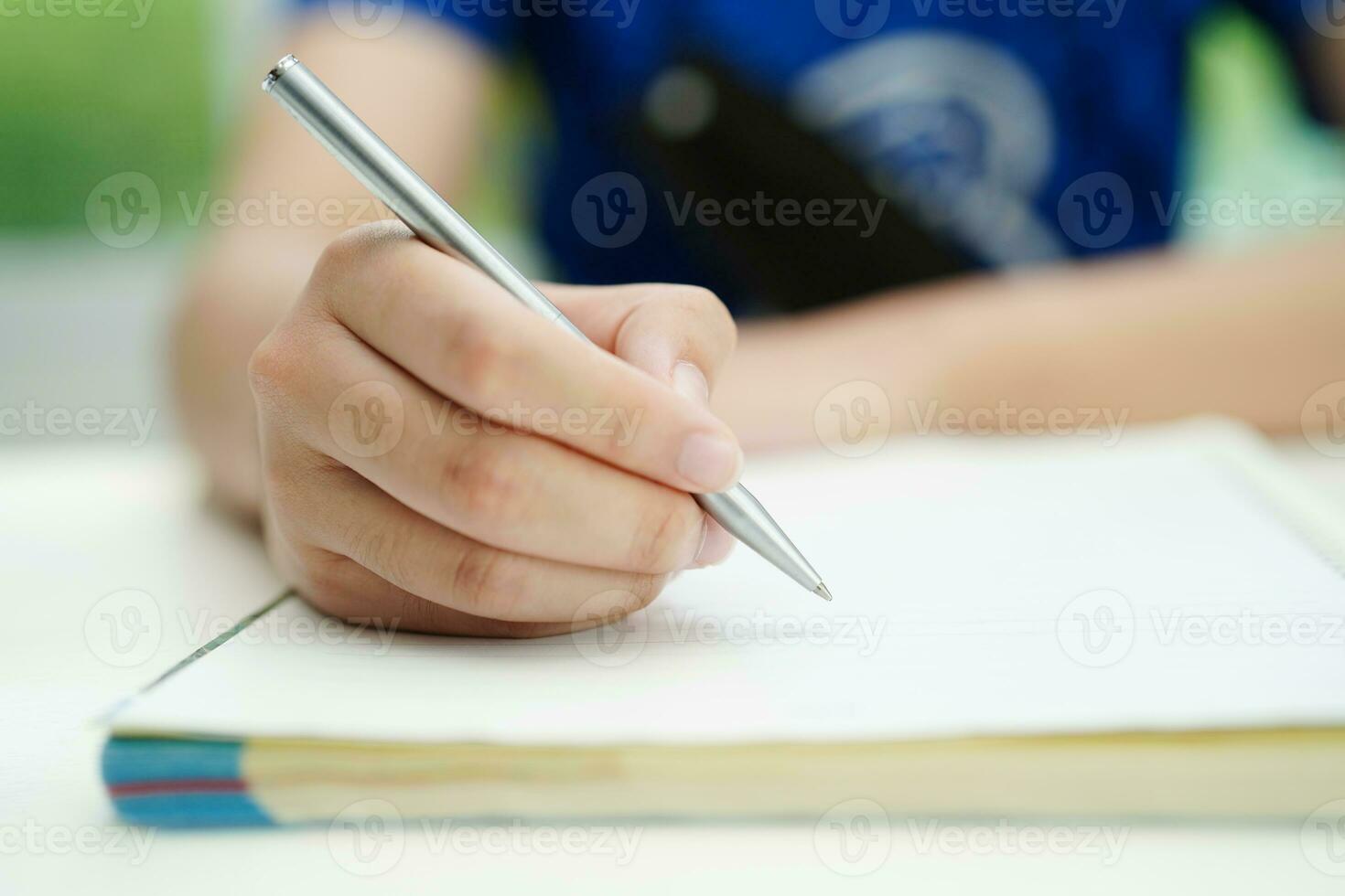 Asian teenage student write homework, study lesson for exam online learning education. photo