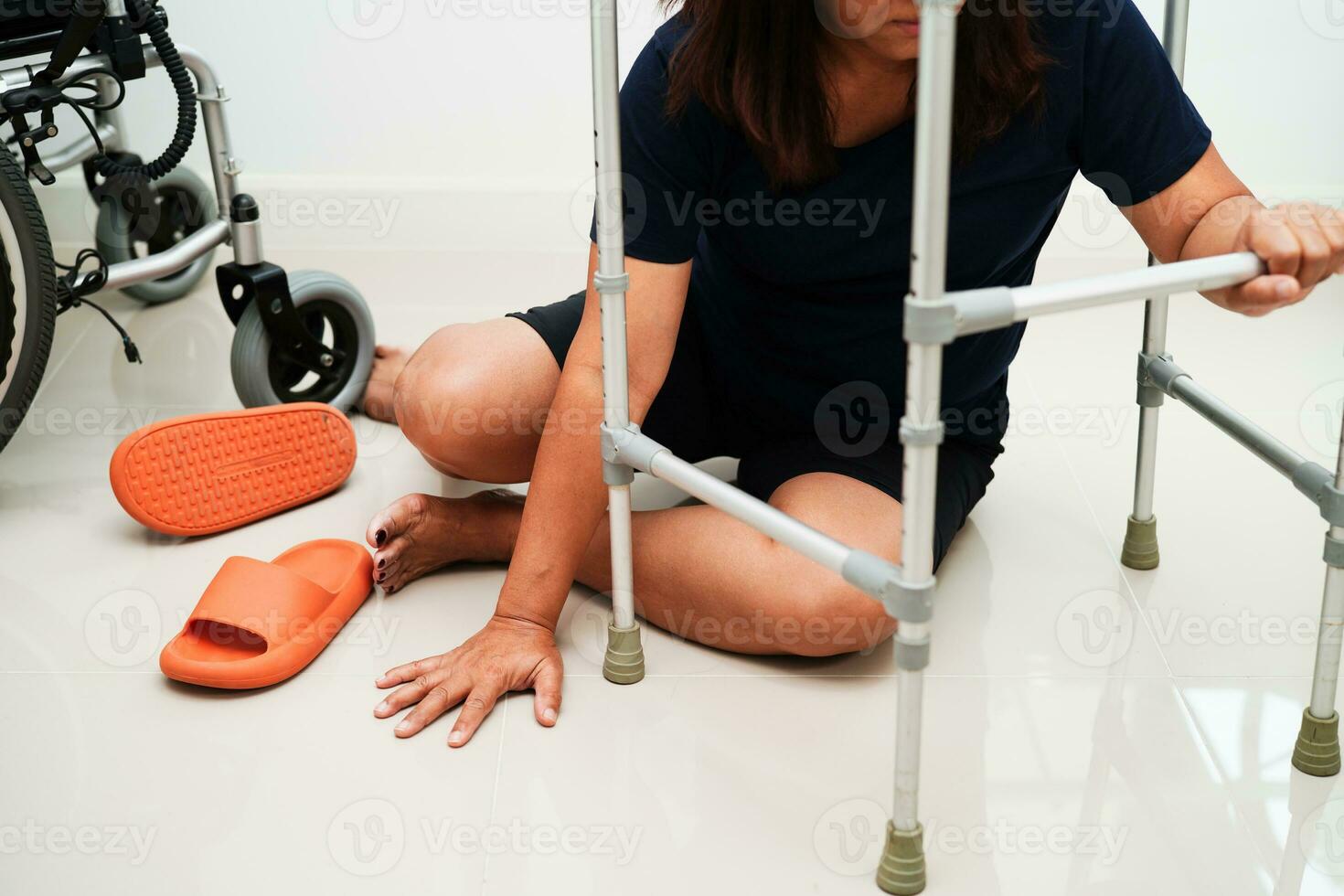 Asian woman injury from falling down on slippery surfaces with walker at home. photo