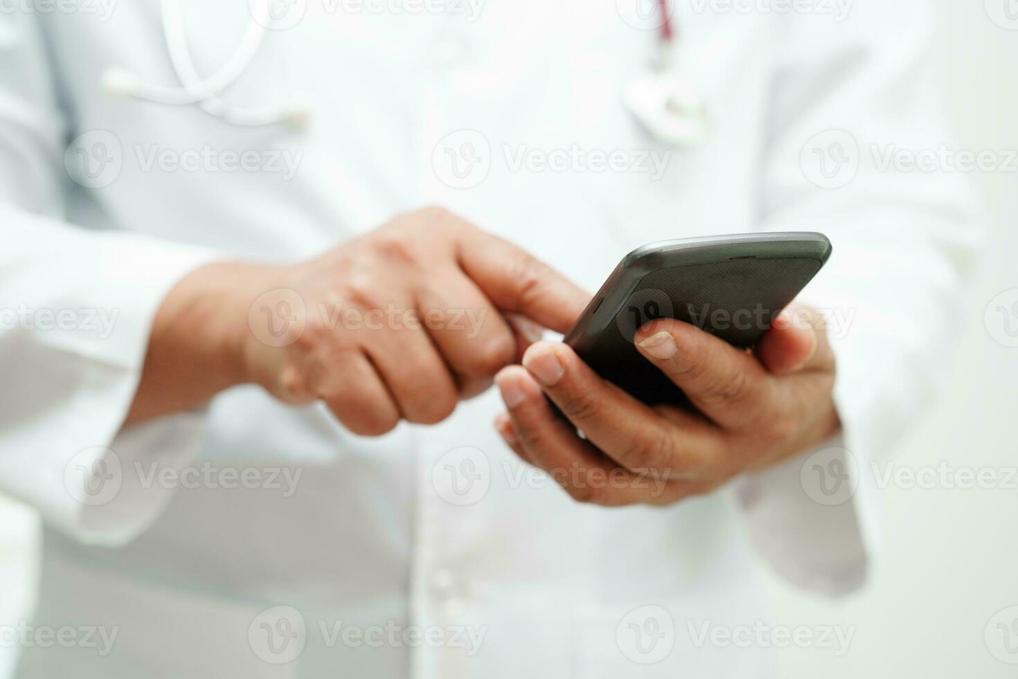 Asian woman doctor holding mobile phone or tablet for search method of treatment patient in hospital. photo