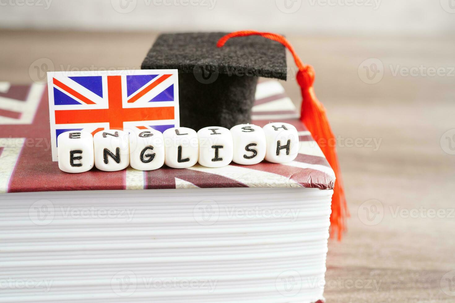 English book with graduate hat, learning and tutorial for foreigner. photo