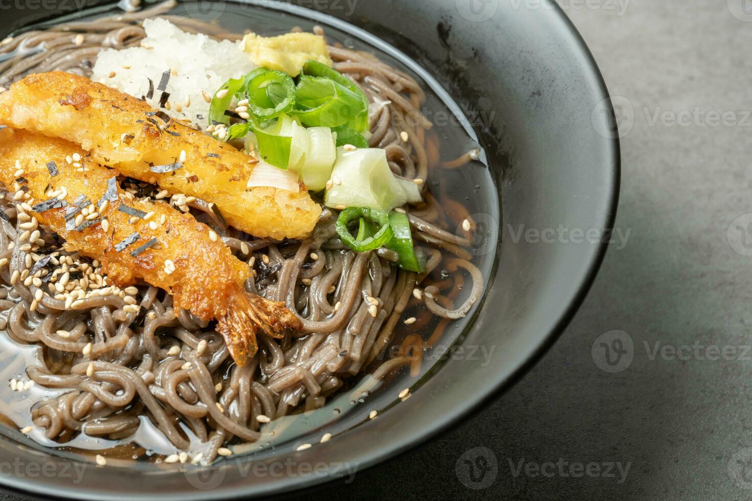 A summer dish of cold wheat noodles with fried shrimp in a black bowl photo
