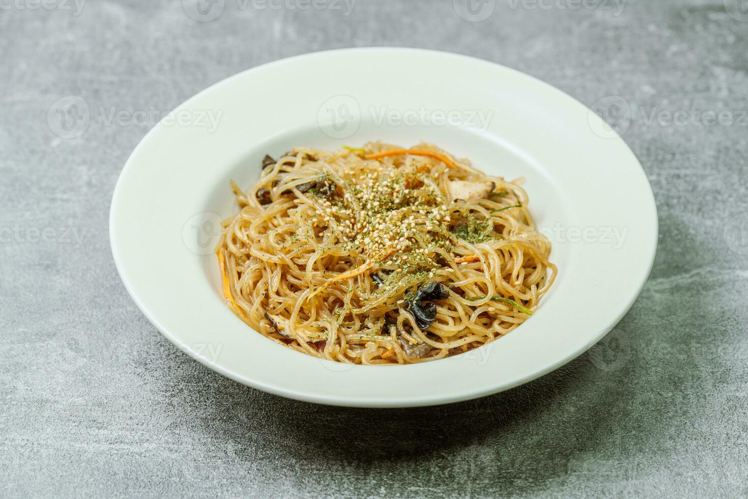 Korean food japchae served on a black plate photo