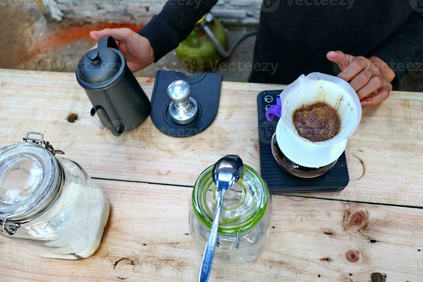 coffee is being poured, showing coffee drops and puffs of steam photo