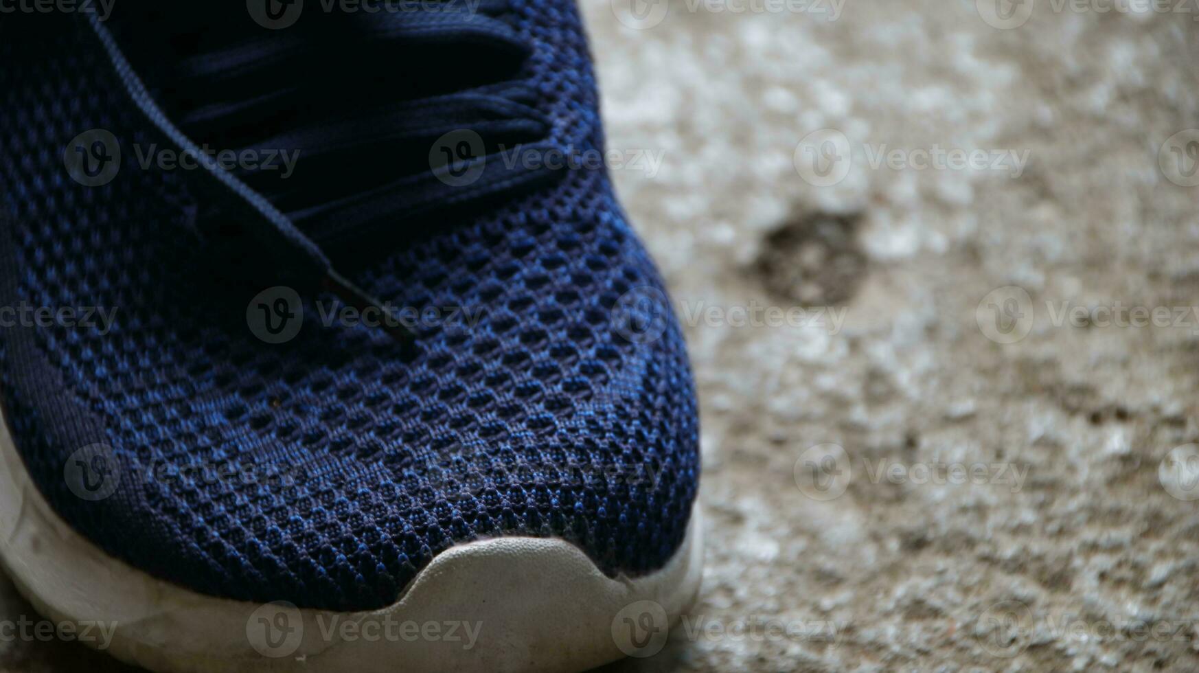 blue sport shoes, blue sneakers on dirty floor photo