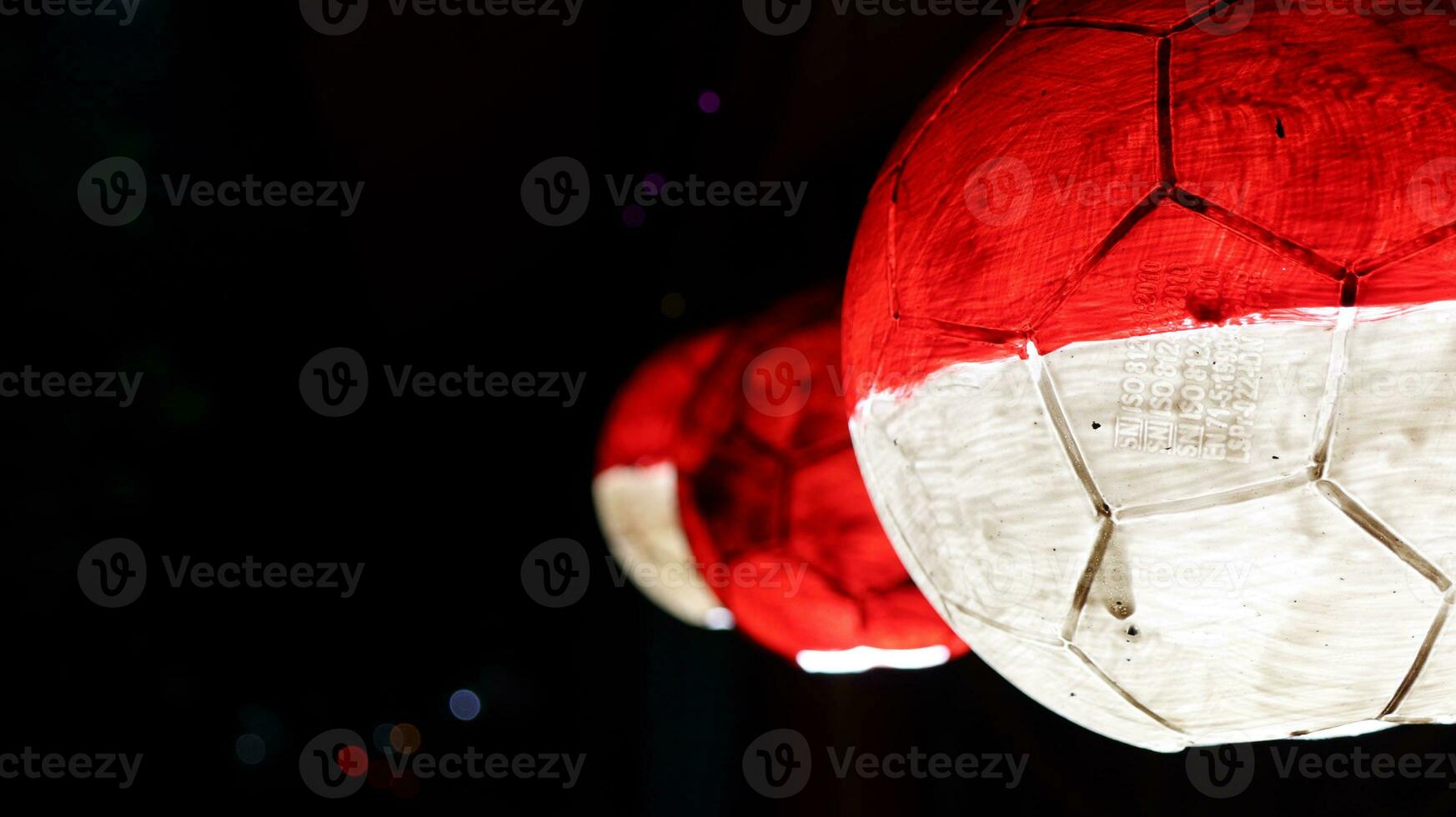 red and white balls hanging on a black background photo