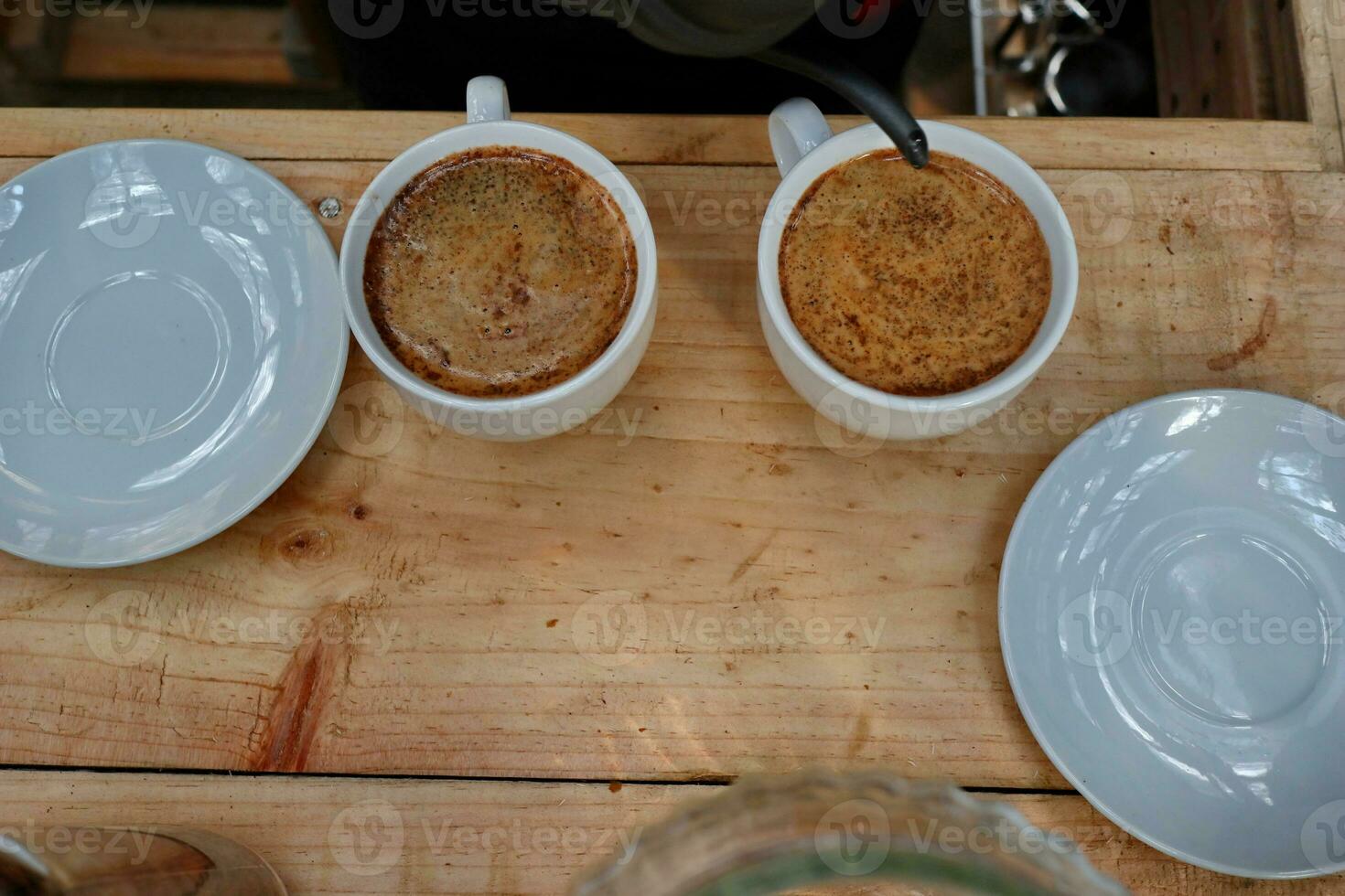 coffee is being poured, showing coffee drops and puffs of steam photo