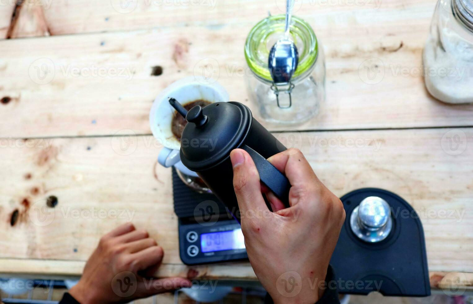coffee is being poured, showing coffee drops and puffs of steam photo