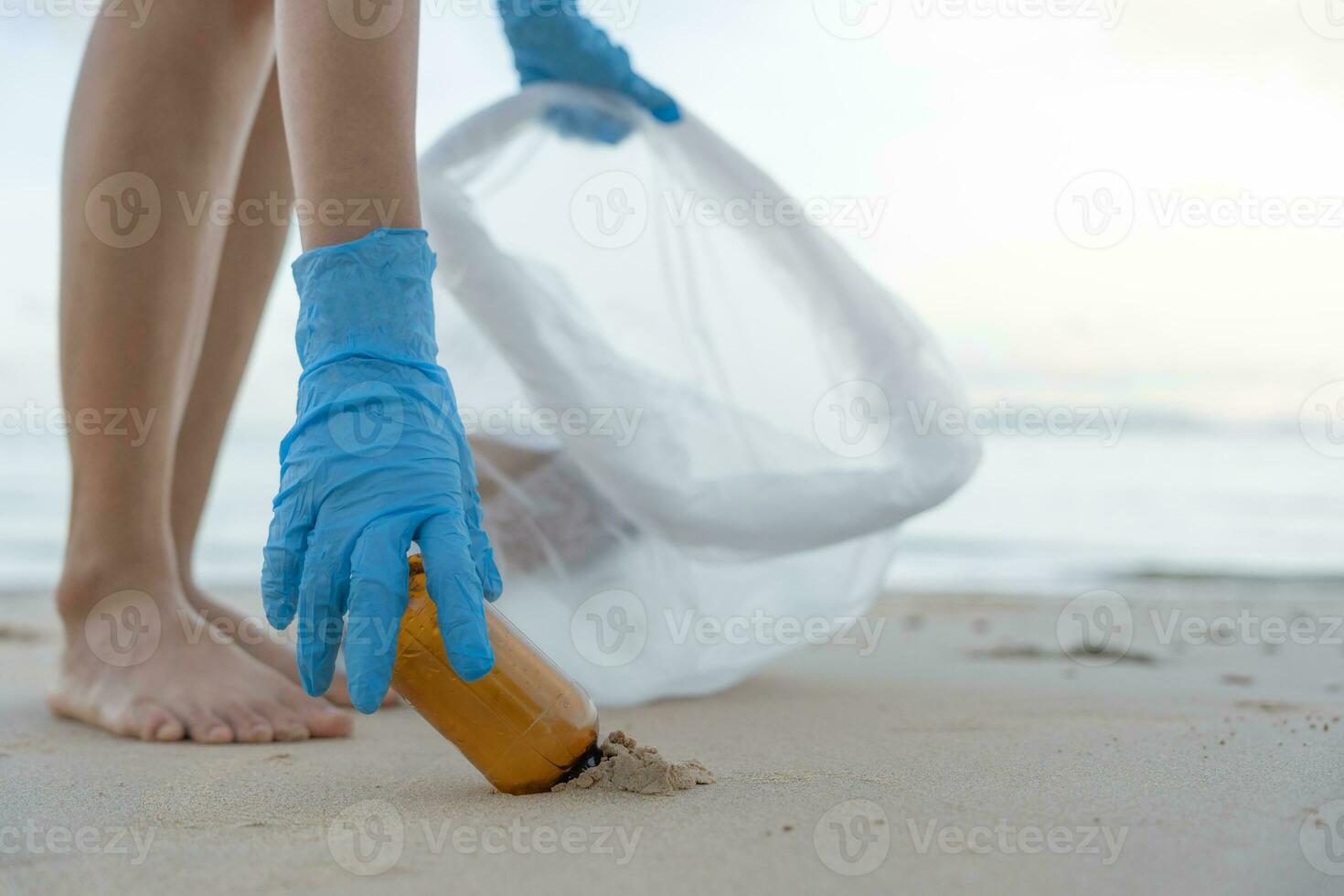 Save ocean. Volunteer pick up trash garbage at the beach and plastic bottles are difficult decompose prevent harm aquatic life. Earth, Environment, Greening planet, reduce global warming, Save world photo