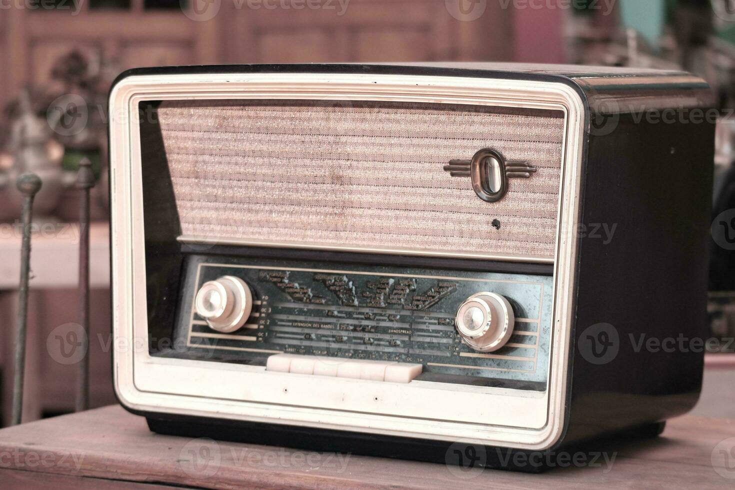 Retro broadcast radio receiver on wooden table circa 1950 photo