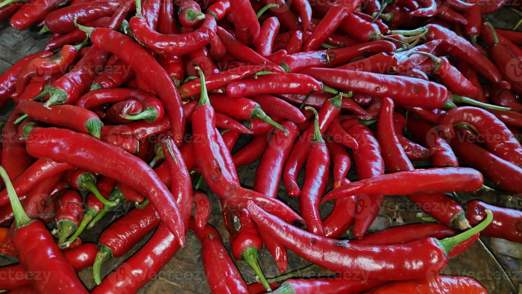 piles of red chili pepper in containers photo