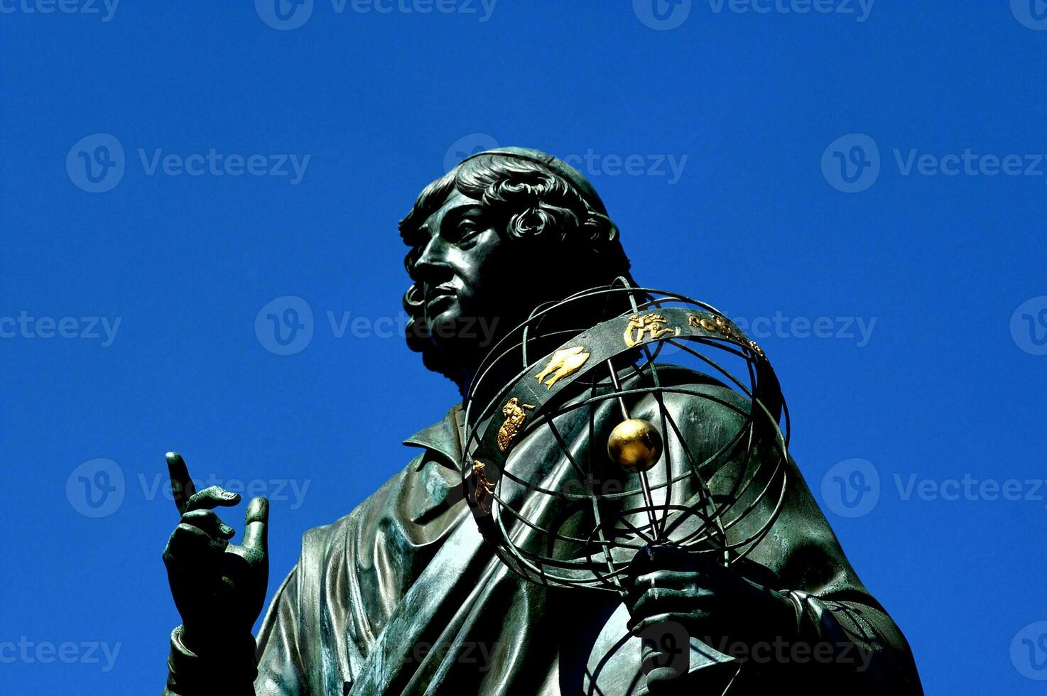 historic monument to astronomer Nicolaus Copernicus in the old city of Torun in Poland on these skies photo