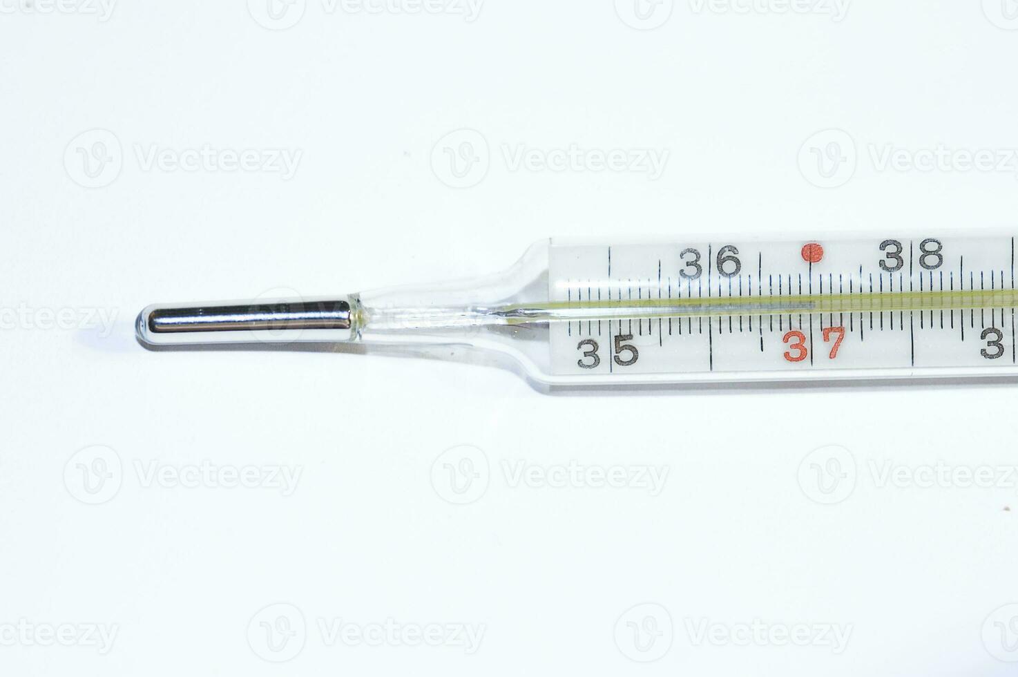 mercury thermometer showing a fever in close-up on a smooth background photo