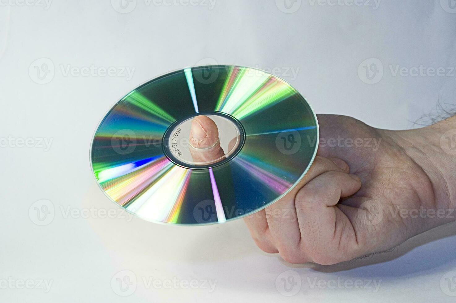 cd disk in male hand on white background photo