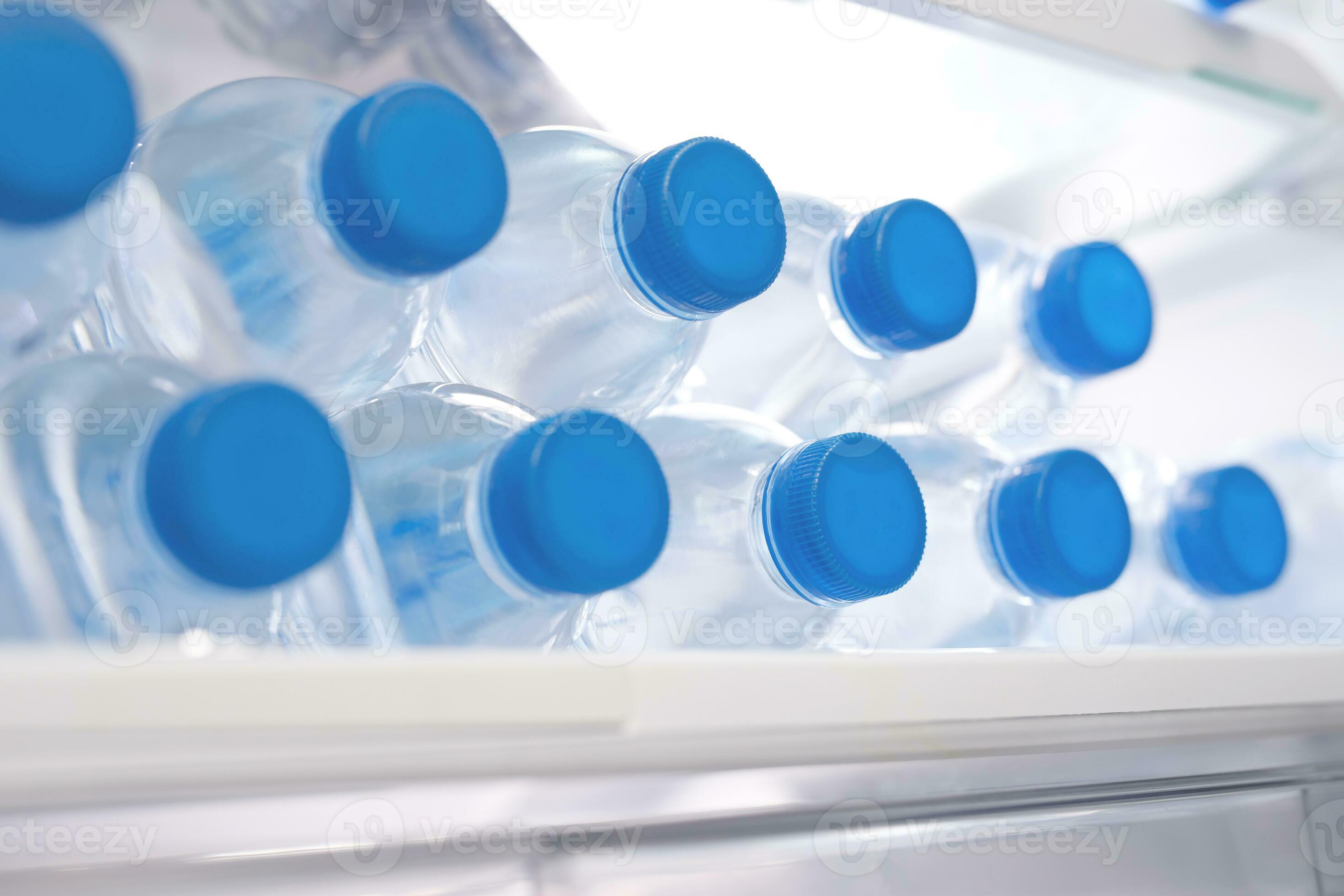 Premium Photo  Cold bottles of clean drinking water in a white refrigerator