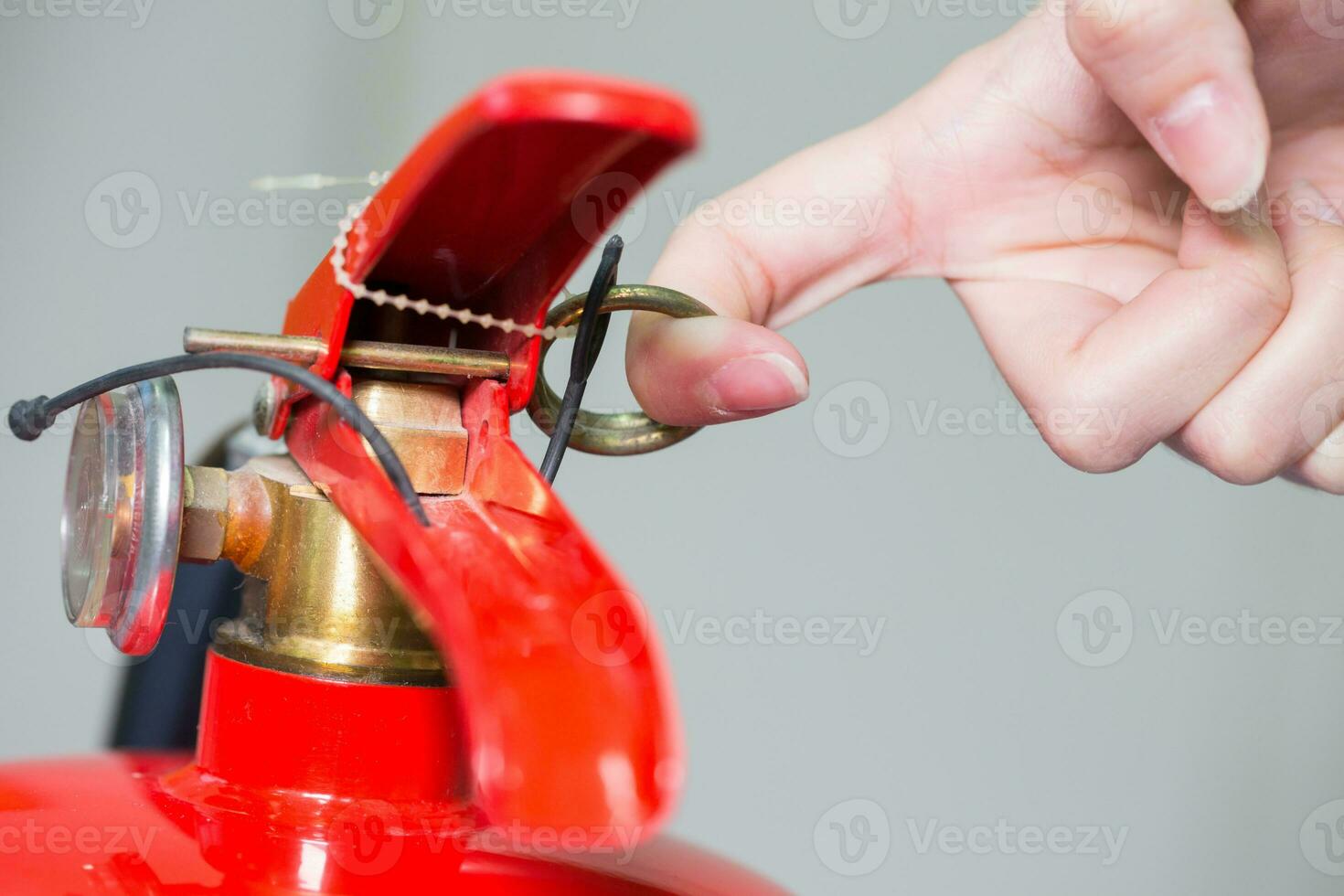 Close- up Fire extinguisher and pulling pin on red tank. photo