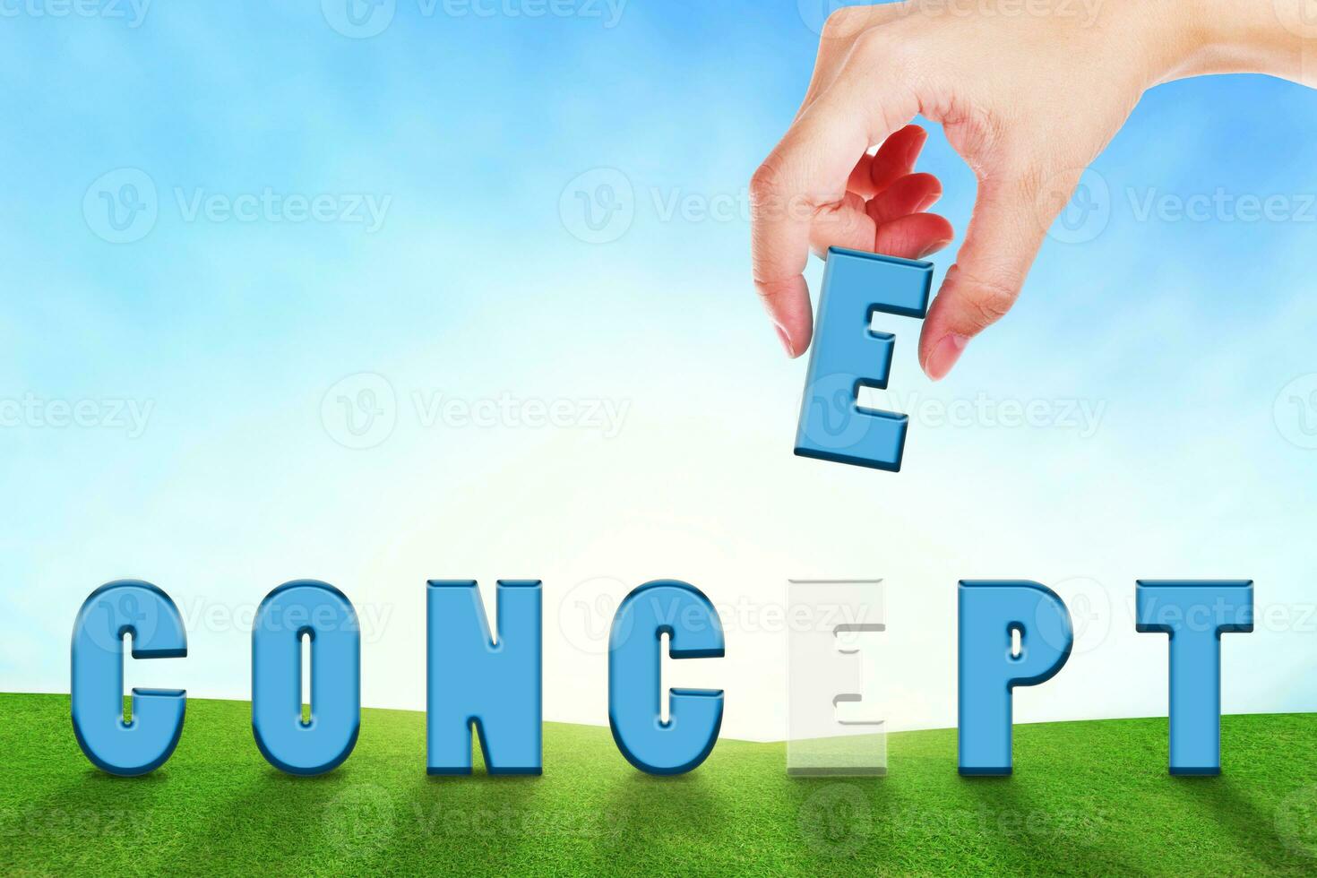 Female hand filling text CONCEPT on grassland. photo