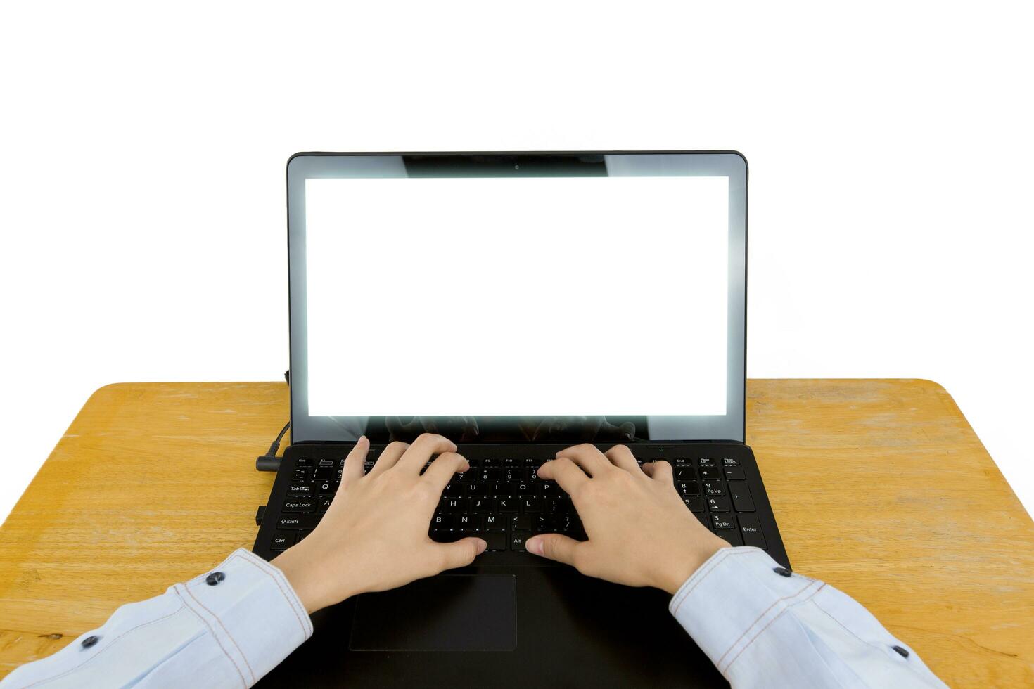 Closeup of women's hands touching type notebook keys during work business on wooden table isolated on white background. photo