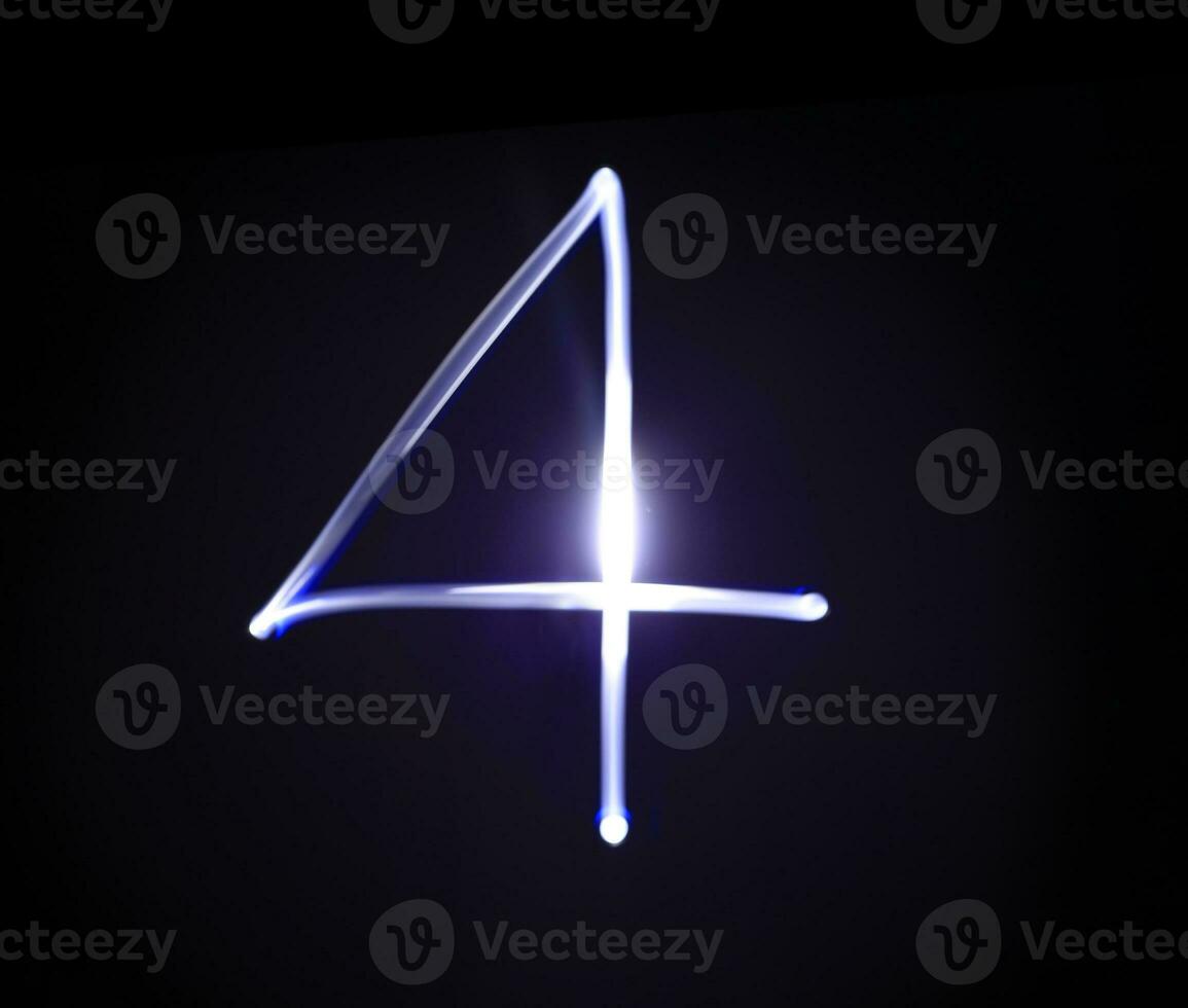 Four blue light digit hand writing over black background. photo