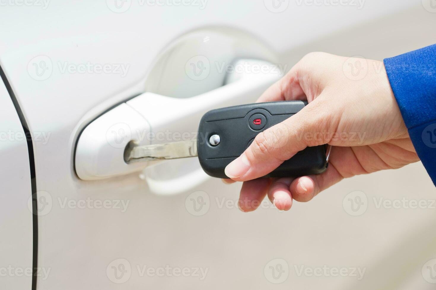 Female hand open the white car on key system automatic. photo