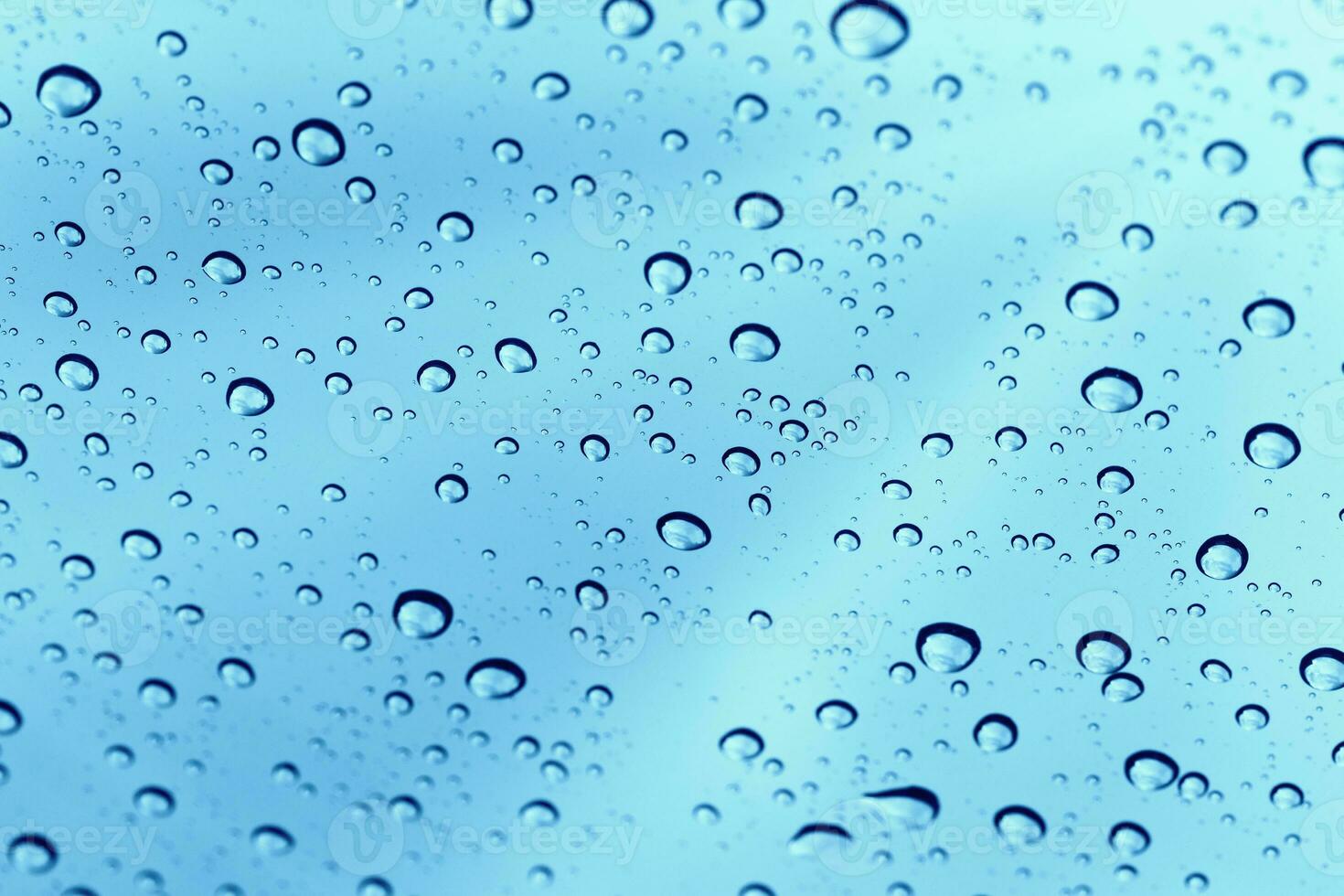 rainy-water-drop-on-glass-mirror-background-27290800-stock-photo-at