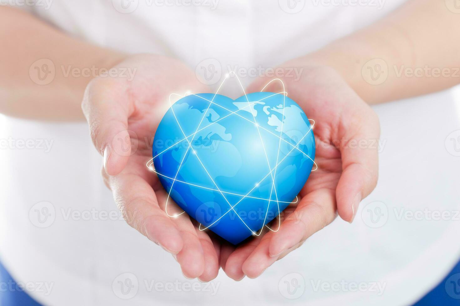 Female hands holding on earth global heart. photo