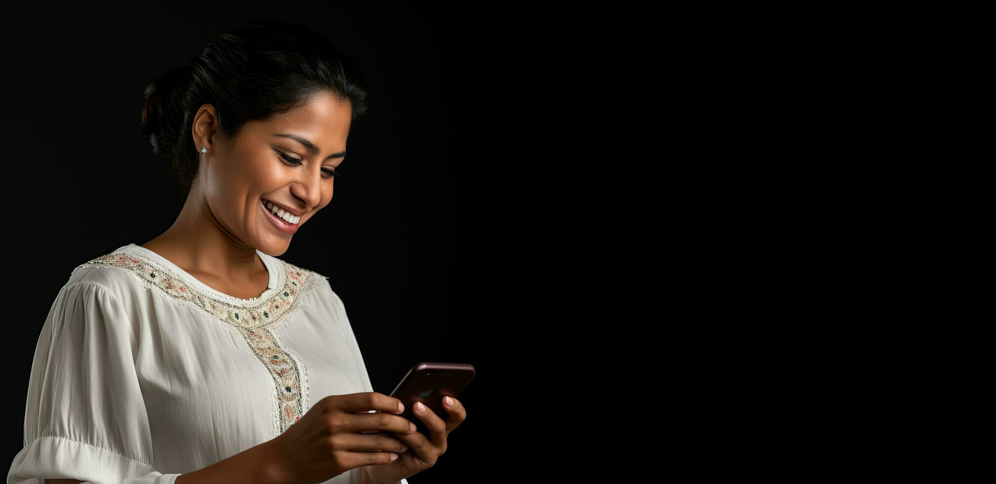 a woman is smiling while using her phone photo