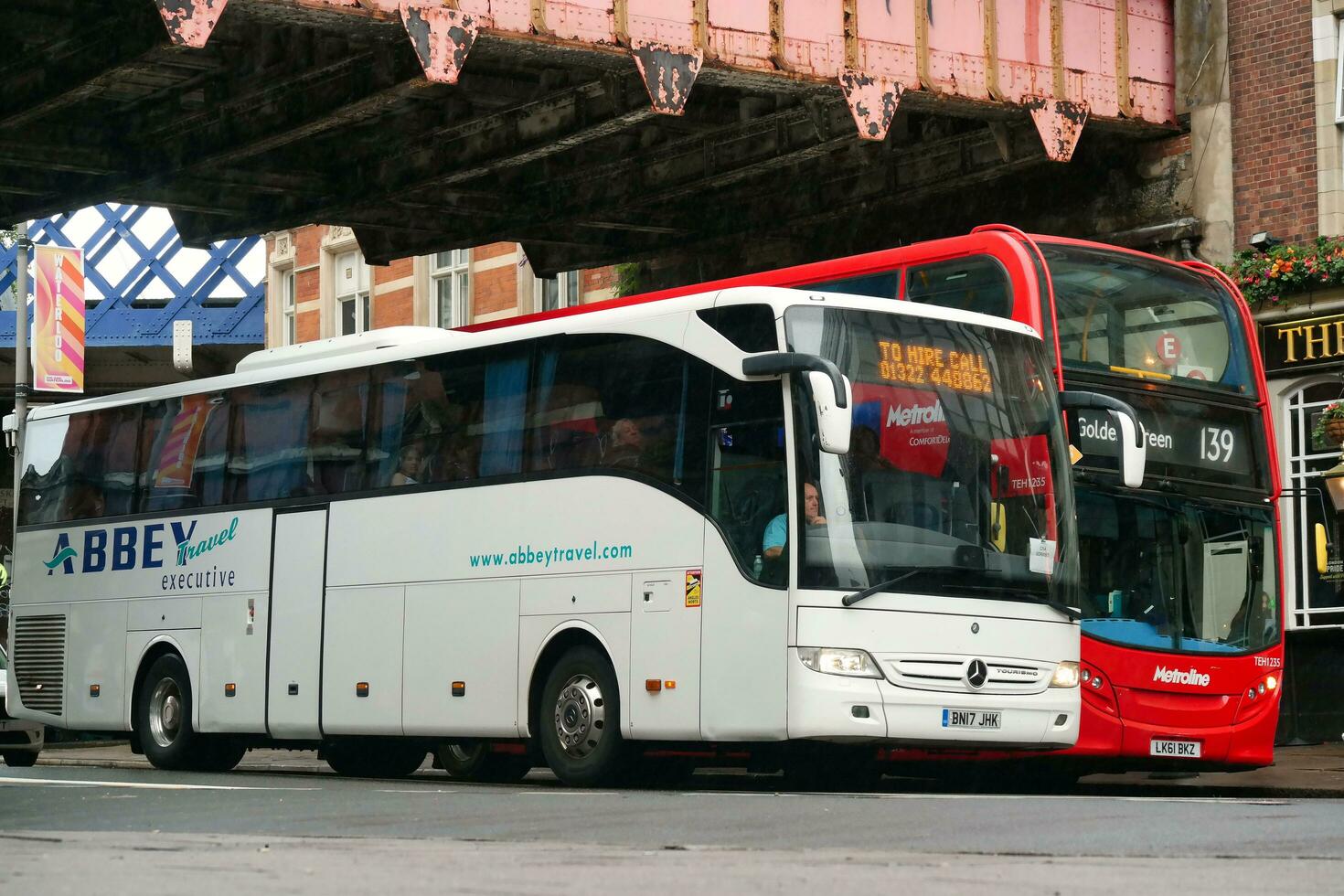 Gorgeous Low Angle view of Bus Service and British Traffic at Central London City of England UK. Image Captured on August 2nd, 2023 During Cloudy and Rainy Day. photo